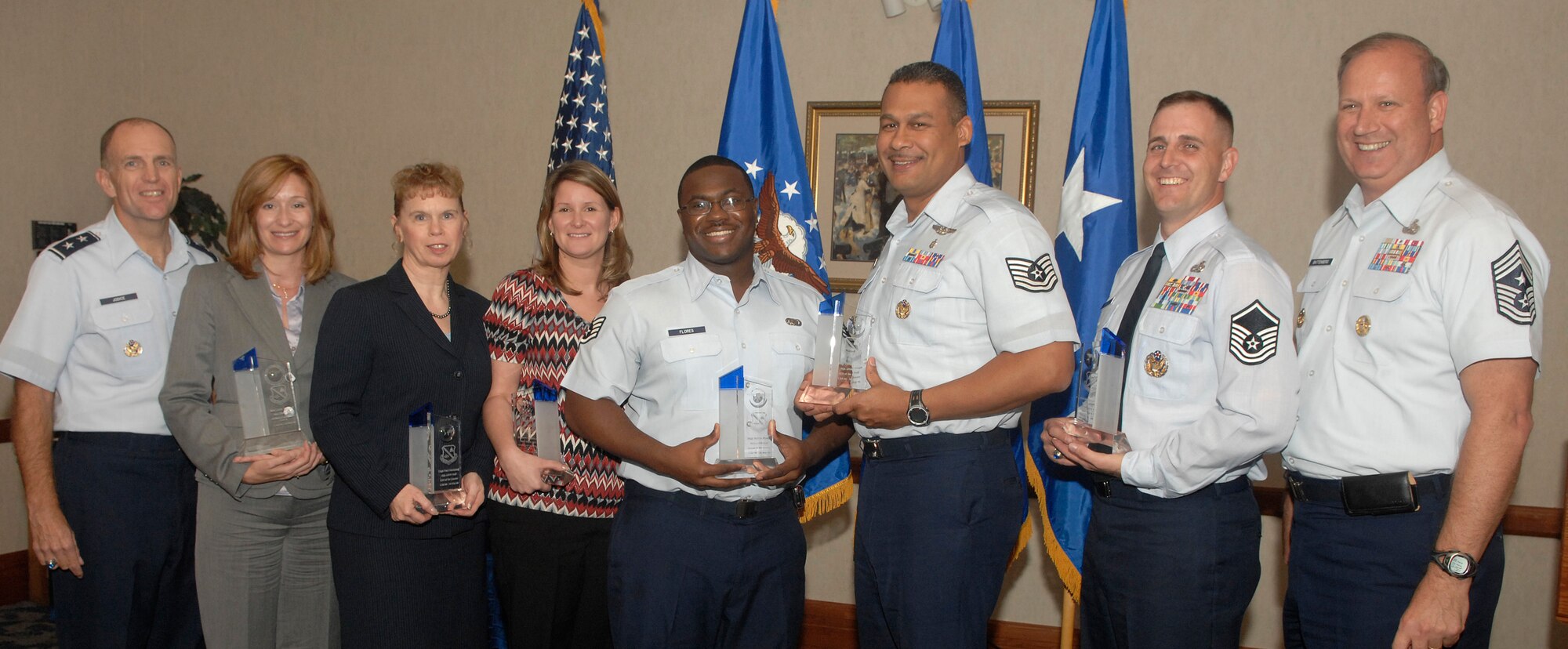 AFDW commander Maj. Gen. Ralph Jodice (far left) and Chief Master Sgt. Pat Battenberg AFDW command chief (far right)  pose with AFDW Quarterly Awards winners. From left to right are:  Ms. Linda Mandell, Ms. Susan Bench-Snow (representing Capt. Hauspurg), Ms. Jennifer Weatherly, Staff Sgt. Felicio Flores, Tech. Sgt. Tyrone Evans and Master Sgt. Charles Mecurio. All award winners will be vying for basewide recognition at the Nov. 6 Team Andrews quarterly awards.  (U.S. Air Force photo by Staff Sgt. Melissa Stonecipher). 

