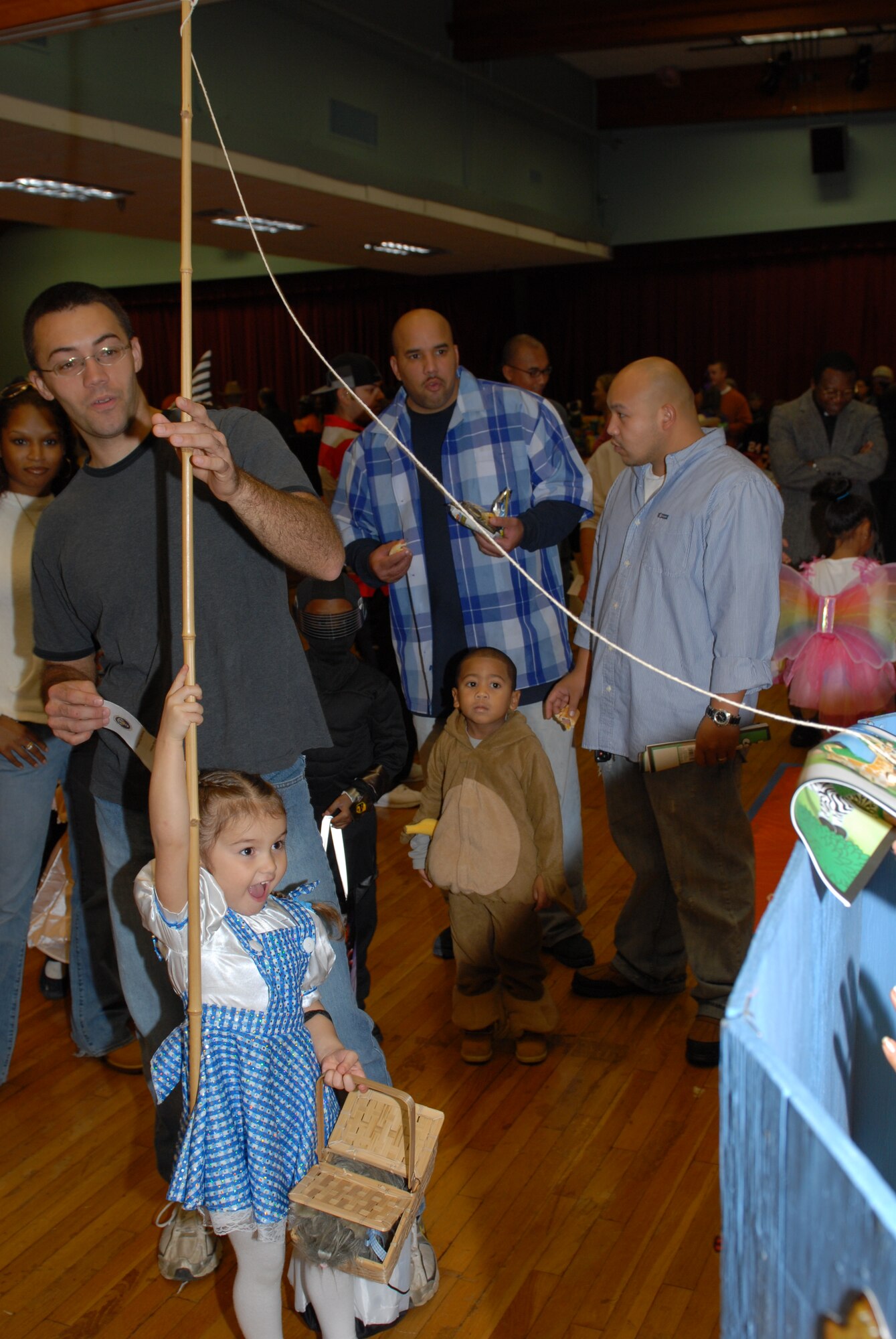 Kiera Cash, daughter of Joshua Cash, 19th Aircraft Maintenance Squadron crew chief, fishes for a prize at the Harvest Festival Oct. 31. More than 800 people participated in the Harvest Festival hosted by the base chapel. (U.S. Air Force photo by Senior Airman Nathan Allen)