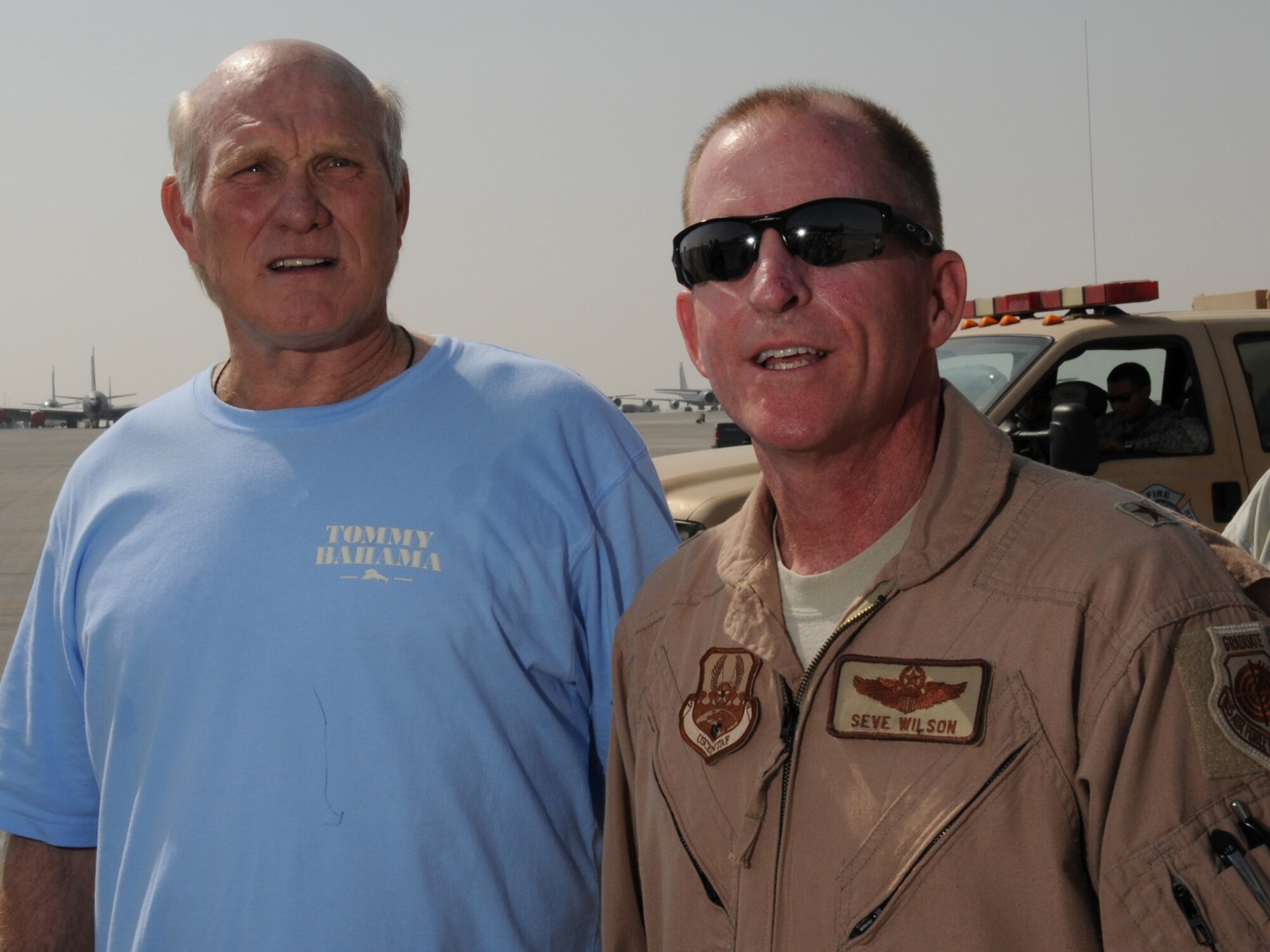 Terry Bradshaw, NFL on FOX analyst and former quarterback for the Pittsburgh Steelers, is greeted by Brig. Gen. Stephen Wilson, 379th Air Expeditionary Wing commander, at an undisclosed location in Southwest Asia, Nov. 5, 2009. Mr. Bradshaw is touring the U.S. Central Command's area of responsibility as part of an Armed Forces Entertainment-sponsored tour. (U.S. Air Force Photo/Tech. Sgt. Jason W. Edwards)