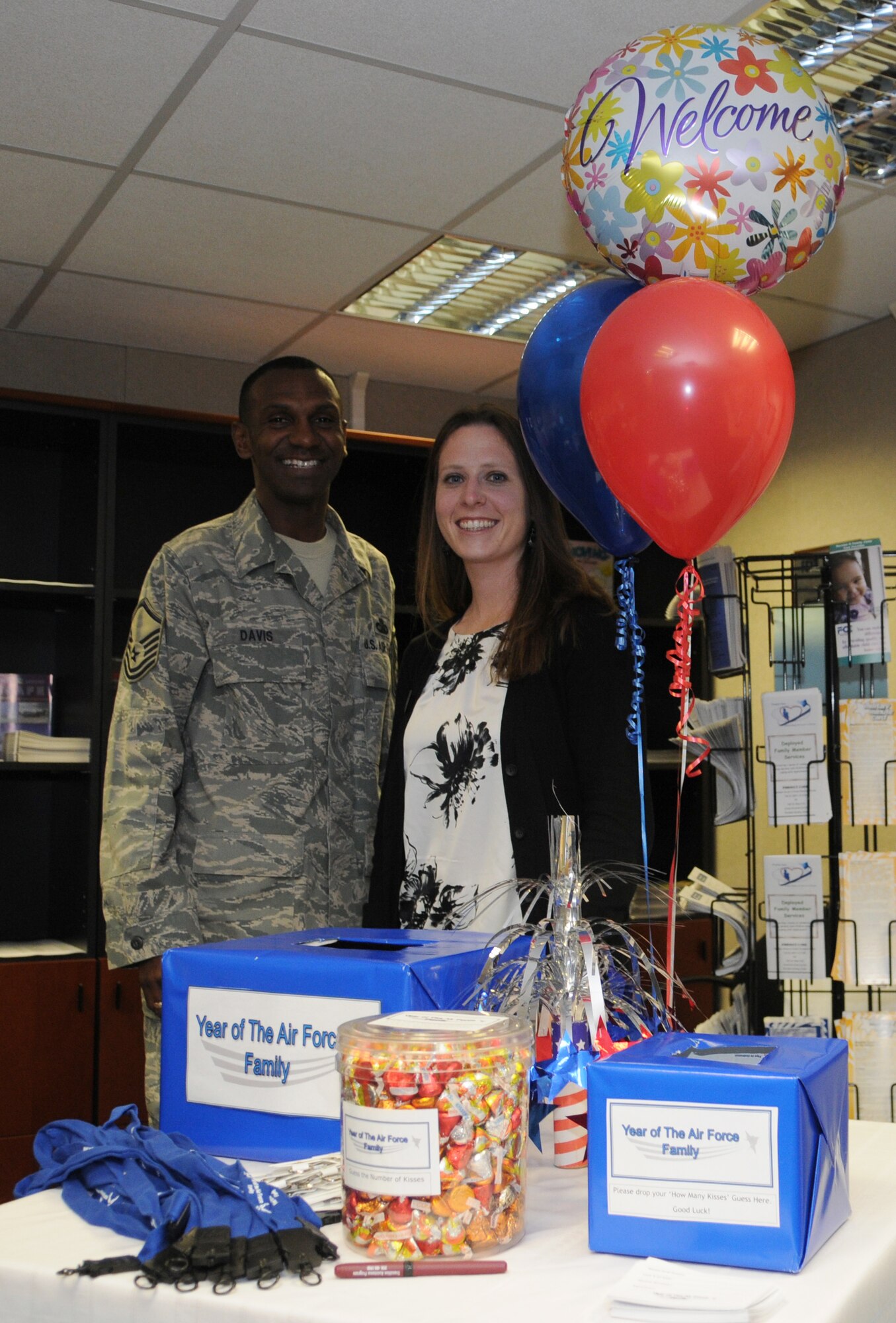 U.S. Air Force Master Sgt. Willis Davis and Ms. Kathleen Moree, 86th Mission Support Squadron community readiness, pose for a photo by the drawing table which will be used to draw give-away prizes during the open house for the Air Force Family Week, Ramstein Air Base, Germany, Nov. 4, 2009. Nov. 1st thru the 7th is designated by Secretary of the Air Force as "Air Force Family Week". (U.S. Air Force photo by Airman 1st Class Caleb Pierce)