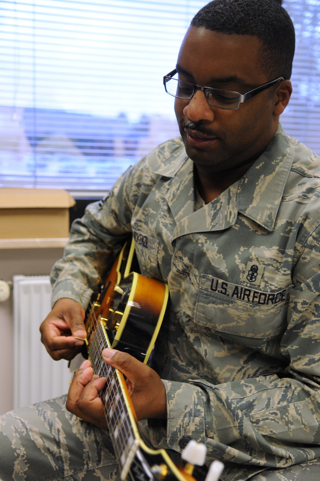 U.S. Air Force Senior Master Sgt. Bruce McKenzie, 86th Medical Operations Squadron superintendent, plays a six-stringed guitar at the Airman and Family Readiness Center open house for Air Force Family Week, Ramstein Air Base, Germany, Nov. 4, 2009. Nov 1st thru the 7th is designated by Secretary of the Air Force as "Air Force Family Week". (U.S. Air Force photo by Airman 1st Class Caleb Pierce)