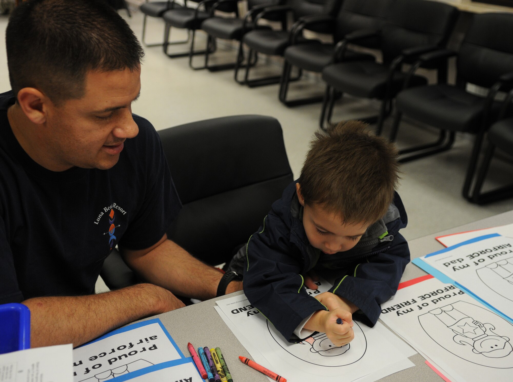 U.S. Air Force 1st Lt. Paul Padilla, 86th Air Evacuation Squadron flight nurse, along with his son August, color pictures in the arts section at the Airman and Family Readiness Center open house for Air Force Family Week, Ramstein Air Base, Germany, Nov. 4, 2009. Nov 1st thru the 7th is designated by Secretary of the Air Force as "Air Force Family Week". (U.S. Air Force photo by Airman 1st Class Caleb Pierce)