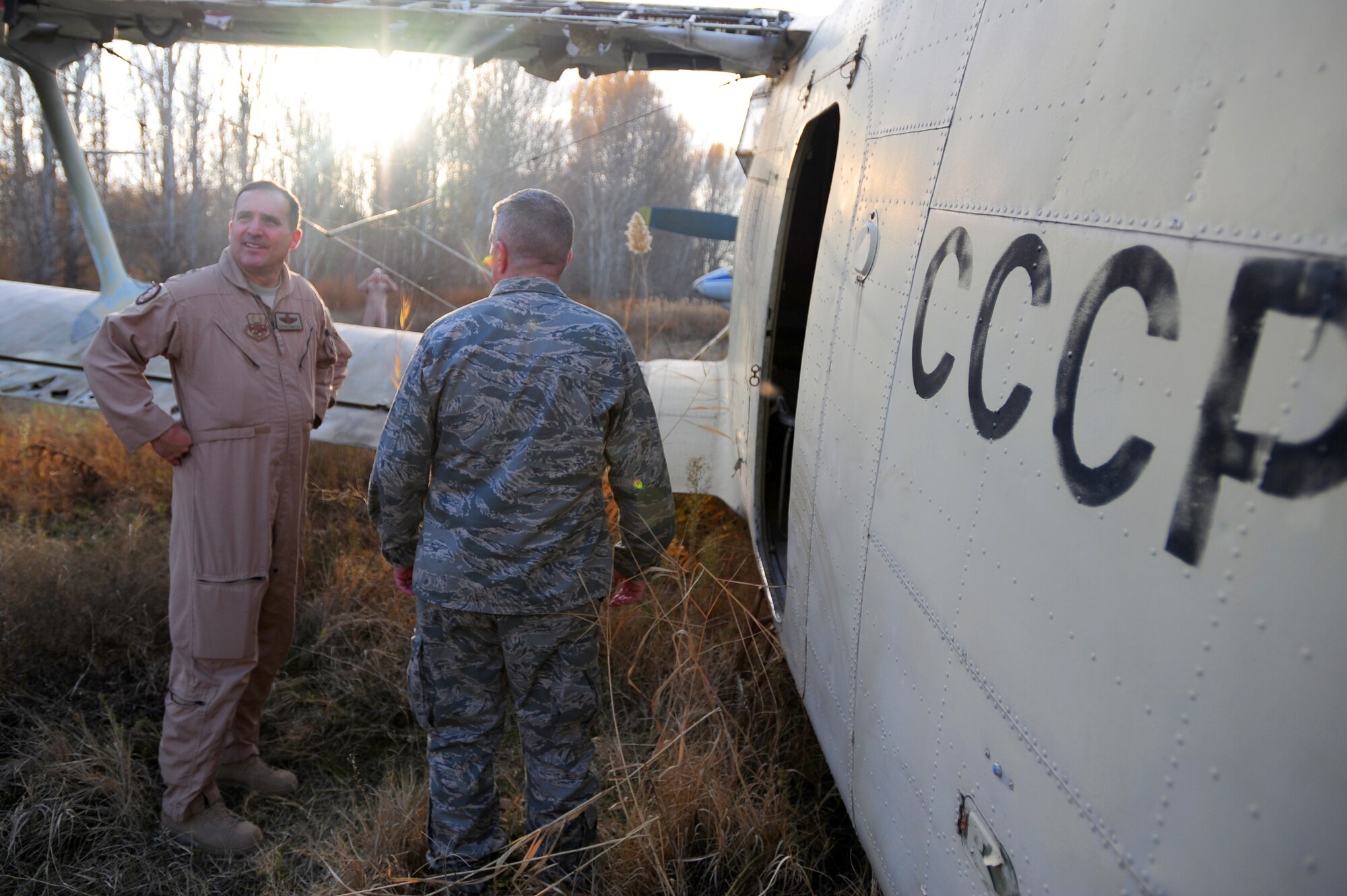 TRANSIT CENTER AT MANAS, Kyrgyzstan -- Maj. Gen. Stephen Mueller, U.S. Air Forces Central Air Component Coordination Element director, and Col. Michael Mahon, 376th Air Expeditionary Wing vice commander tour Soviet aircraft at the 'boneyard' at the Transit Center, Nov. 3, 2009. (U.S. Air Force photo/Senior Airman Steele C. G. Britton)