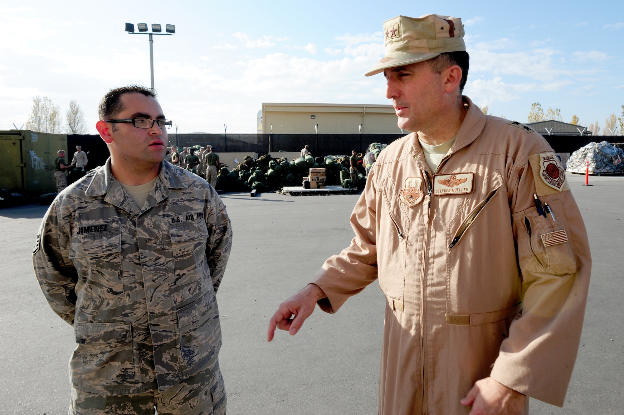 TRANSIT CENTER AT MANAS, Kyrgyzstan -- Maj. Gen. Stephen Mueller, U.S. Air Forces Central Air Component Coordination Element director, discusses onward troop movement with Staff Sgt. Hector Jimenez, 376th Expeditionary Logistics Readiness Squadron passenger terminal day shift supervisor, at the Transit Center, Nov. 3, 2009. Gen. Mueller is visiting from Kabul, Afghanistan to better his knowledge on the missions of the Transit Center in support of Operation ENDURING FREEDOM. Sergeant Jimenez is deployed from the 62nd Aerial Port Squadron at McChord Air Force Base, Wash.  (U.S. Air Force photo/Senior Airman Steele C. G. Britton)