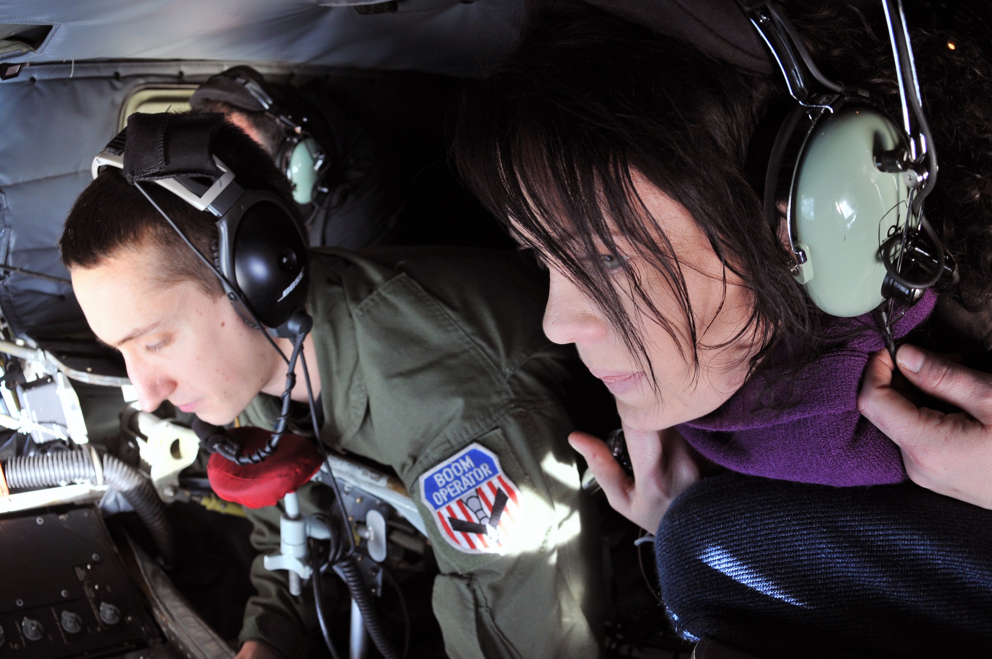 Staff Sgt. Jonathan Brown, 100th Operations Support Squadron boom operator, refuels a 48th Fighter Wing F-15E Strike Eagle from RAF Lakenheath, England above East Anglia as Ruth Cresswell, Great Heath Primary School teacher, watches attentively during a Community Orientation Flight Nov. 4. Nearly 100 civic leaders, honorary commanders, local educators, constables and British-American Committee members were selected to fly as part of this year's program. (U.S. Air Force photo/Tech. Sgt. Kevin Wallace)