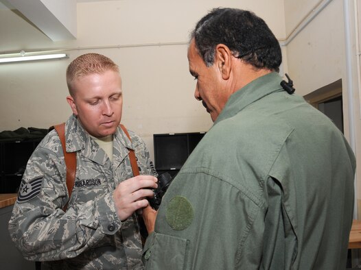 CAMP TAJI, Iraq -- Air Force Tech. Sgt. Kyle Richardson, 721st Air Expeditionary Advisory Squadron air crew flight equipment advisor, inspects night vision goggles Oct. 30, 2009. Sergeant Richardson ensures the Iraqi air force airmen he advises properly maintain survival vests, body armor, crash helmets and NVGs for more than 200 Iraqi helicopter air crew members. Sergeant Richardson is deployed from Shaw Air Force Base, S.C., and hails from Orleans, Ind. (U.S. Air Force photo/Tech. Sgt. Johnny L. Saldivar)

