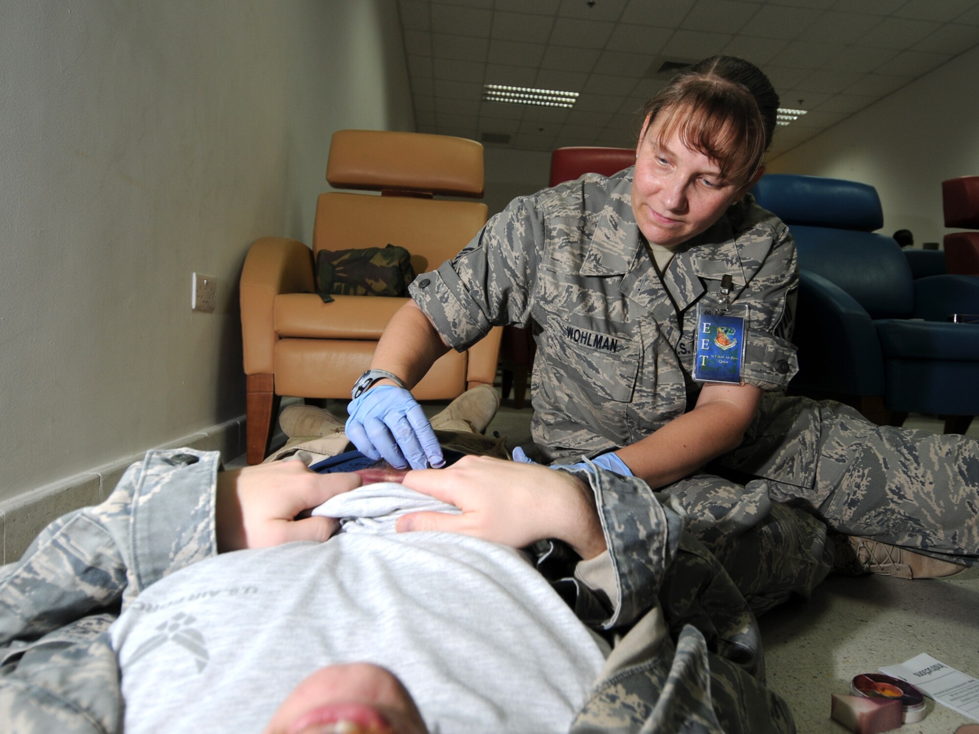 Master Sgt. Chyrle Wohlman, 379th Expeditionary Medical Group primary care and emergency services NCOIC, applies make-up to a simulated casualty prior to a basewide exercise at an undisclosed location in Southwest Asia, Nov. 3, 2009. Personnel assigned to the 379th Air Expeditionary Wing and other tenant units participate in exercises regularly to train on a variety of potential real-world scenarios. Sergeant Wohlman is deployed from McGuire Air Force Base, N.J. in support of operations Iraqi Freedom and Enduring Freedom. (U.S. Air Force Photo/Tech. Sgt. Jason W. Edwards)
