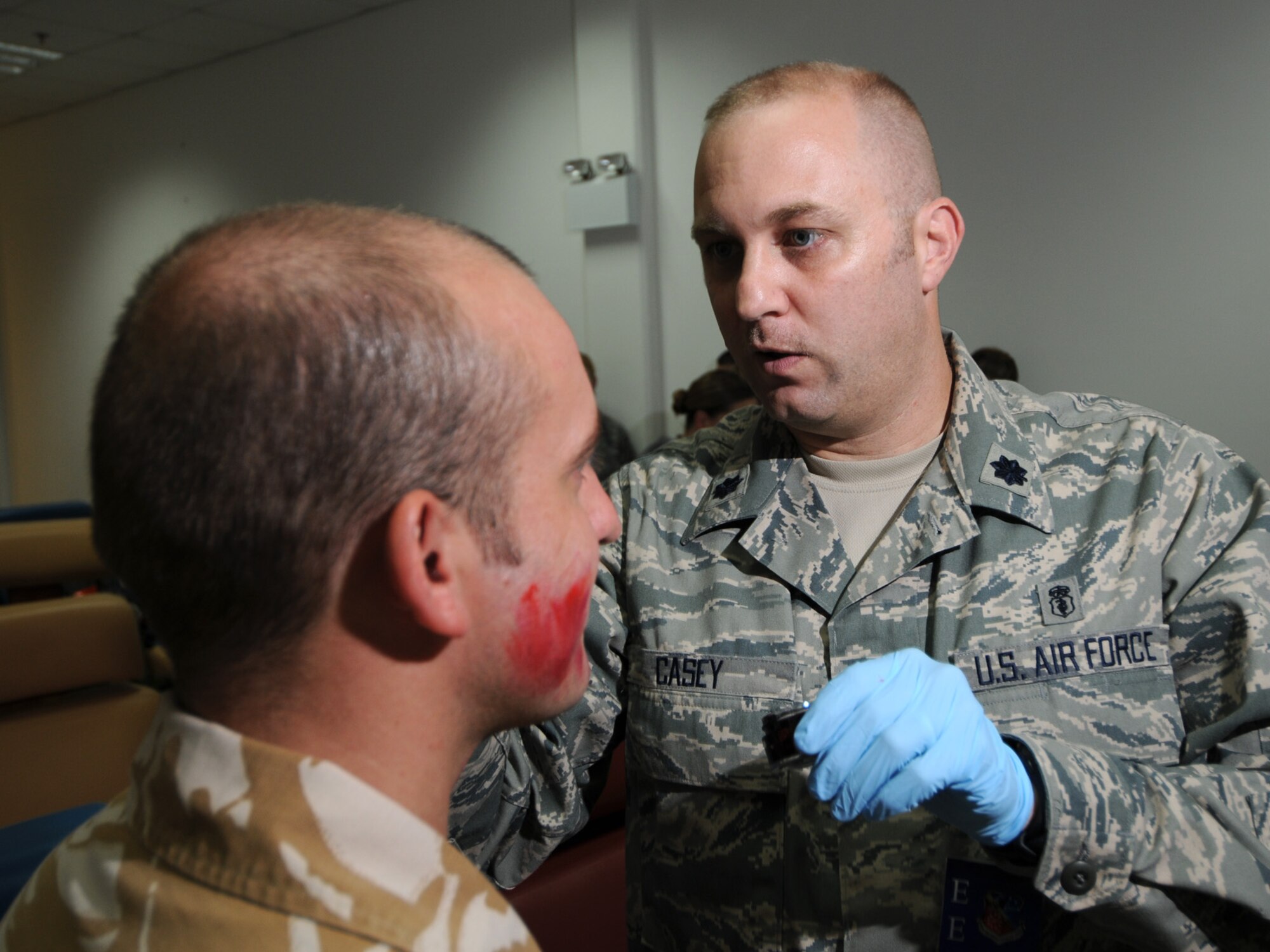 Lt. Col. (Dr.) Jeffery Casey, 379th Expeditionary Medical Group chief of dental services, applies make-up to a simulated casualty prior to a basewide exercise at an undisclosed location in Southwest Asia, Nov. 3, 2009. Personnel assigned to the 379th Air Expeditionary Wing and other tenant units participate in exercises regularly to train on a variety of potential real-world scenarios. Dr. Casey is deployed from Elmendorf Air Force Base, Alaska, in support of operations Iraqi Freedom and Enduring Freedom. (U.S. Air Force Photo/Tech. Sgt. Jason W. Edwards)