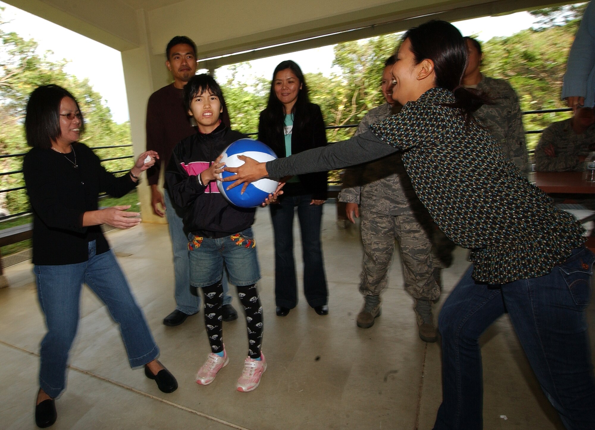 Asahi Ryo special needs school students, along with military members and their families, took part in a balloon game similar to musical chairs during a barbecue at Rodriguez Park, Nov. 3, at Kadena Air Base, Japan. This was the first time the students experienced an American barbecue as they spent the entire “Culture Day” interacting with military members while enjoying food and fun. (U.S. Air Force photo/Tech. Sgt. Rey Ramon)       