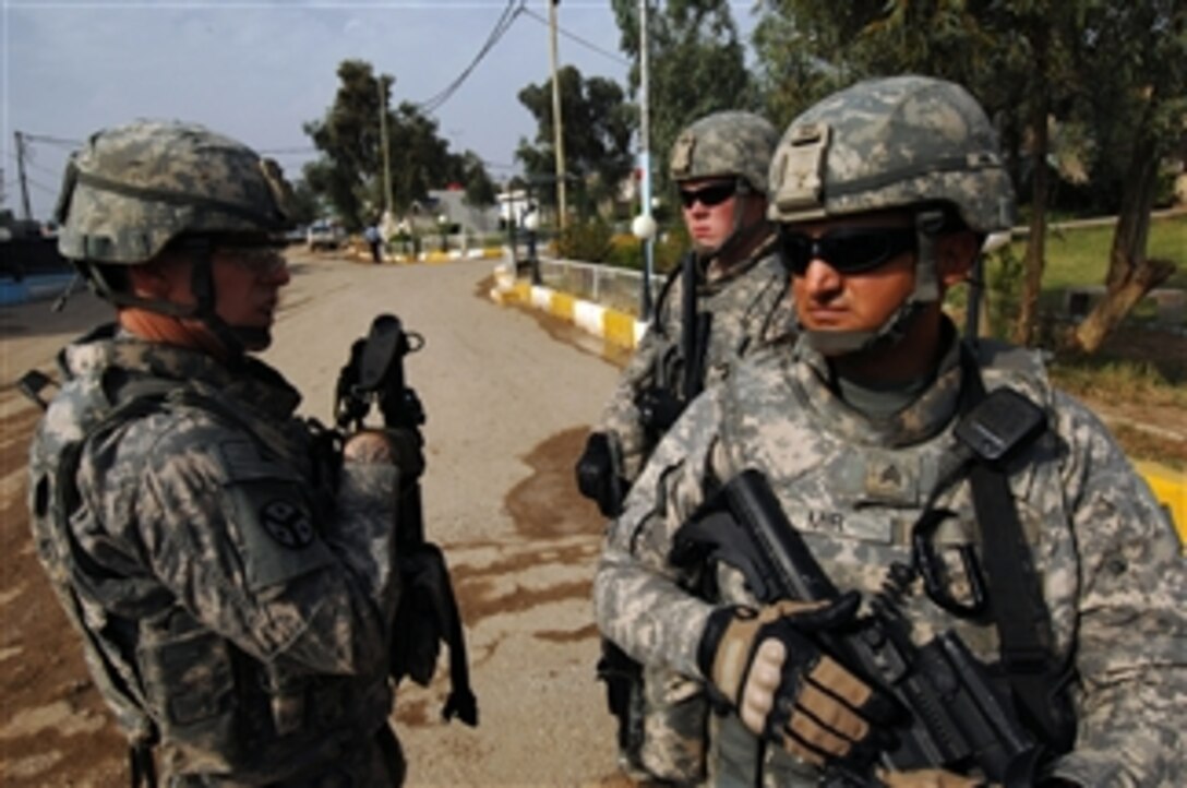 U.S. Army soldiers from the 3rd Platoon, 252nd Military Police Company provide security during a meeting with the Iraqi Police at their headquarters in Kut, Iraq, on Nov. 2, 2009.  The soldiers visited to discuss ongoing operations in the area.  