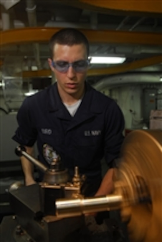 U.S. Navy Seaman Cameron Bird fabricates a deck pin in the machine shop aboard the aircraft carrier USS John C. Stennis (CVN 74) while the ship is underway in the Pacific Ocean on Nov. 3, 2009.  The Stennis is in transit to southern California to participate in a strike group sustainment exercise.  