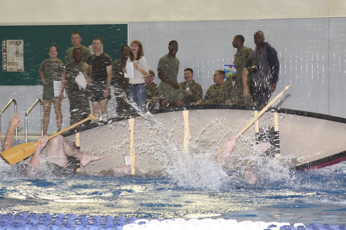 Marines lose control of their canoe and fall overboard during the Gladiators event at the IronWorks Gym pool here Nov. 6. The Gladiators event is the final competition of the Commander’s Cup Challenge. During the Gladiators event, there was a total of nine competitions with four teams testing their strength, endurance and teamwork.