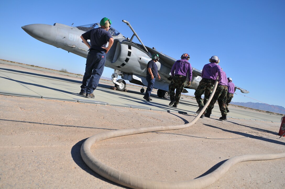 Navy aviation fuel technicians from the USS Green Bay step up to refuel an AV-8B Harrier from Air Test and Evaluation Squadron 31 at Auxiliary Airfield 2 in Yuma, Ariz., Nov. 5, 2009. The squadron and the USS Green Bay flight deck crew practiced working together at the airfield, which simulates the deck of a ship, to prepare for their upcoming testing period aboard the Green Bay. The Green Bay, commissioned January 2009, is part of the Navy’s new class of amphibious transport dock ship built specifically for helicopter operations. The squadron tested Harrier operations aboard the ship Nov. 11-15, 2009, to ensure that its design doesn’t inhibit use by Harriers in case of emergencies. Since the Green Bay is intended for helicopter use, many of its flight crew are inexperienced working with Harriers.  “A lot of our crew members are very new to the fleet and many have never worked with jets before,” said Petty Officer 1st Class Albaro Rodriguez, USS Green Bay aviation fuel technician. “This is giving them a good chance to get prepared for possible emergency situations.”