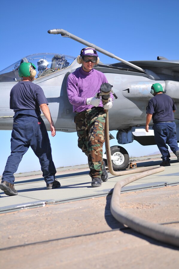 Seaman William Benson, aviation fuel technician from the USS Green Bay, backs away from the refueling point after refueling an AV-8B Harrier from Air Test and Evaluation Squadron 31 at Auxiliary Airfield 2 in Yuma, Ariz., Nov. 5, 2009. The squadron and the USS Green Bay flight deck crew practiced working together at the airfield, which simulates the deck of a ship, to prepare for their upcoming testing period aboard the Green Bay. The Green Bay, commissioned January 2009, is part of the Navy’s new class of amphibious transport dock ship built specifically for helicopter operations. The squadron tested Harrier operations aboard the ship Nov. 11-15, 2009, to ensure that its design doesn’t inhibit use by Harriers in case of emergencies. Since the Green Bay is intended for helicopter use, many of its flight crew are inexperienced working with Harriers.  “A lot of our crew members are very new to the fleet and many have never worked with jets before,” said Petty Officer 1st Class Albaro Rodriguez, USS Green Bay aviation fuel technician. “This is giving them a good chance to get prepared for possible emergency situations.”