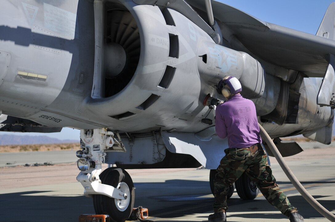 Seaman William Benson, aviation fuel technician from the USS Green Bay, attaches a fuel line to an AV-8B Harrier from Air Test and Evaluation Squadron 31 at Auxiliary Airfield 2 in Yuma, Ariz., Nov. 5, 2009. The squadron and the USS Green Bay flight deck crew practiced working together at the airfield, which simulates the deck of a ship, to prepare for their upcoming testing period aboard the Green Bay. The Green Bay, commissioned January 2009, is part of the Navy’s new class of amphibious transport dock ship built specifically for helicopter operations. The squadron tested Harrier operations aboard the ship Nov. 11-15, 2009, to ensure that its design doesn’t inhibit use by Harriers in case of emergencies. Since the Green Bay is intended for helicopter use, many of its flight crew are inexperienced working with Harriers.  “A lot of our crew members are very new to the fleet and many have never worked with jets before,” said Petty Officer 1st Class Albaro Rodriguez, USS Green Bay aviation fuel technician. “This is giving them a good chance to get prepared for possible emergency situations.”