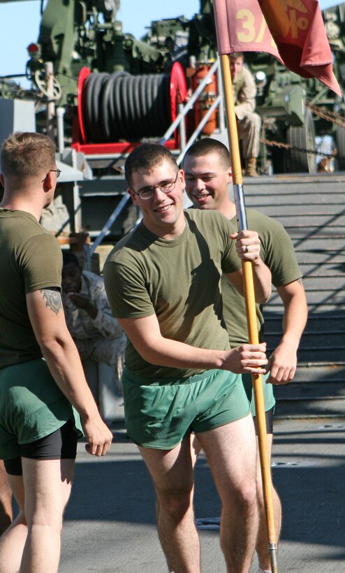Lance Cpl. Tyler J. Easley, a rifleman with 2nd Platoon, India Company, Battalion Landing Team, 3rd Battalion, 2nd Marine Regiment, 22nd Marine Expeditionary Unit, and native of Mobile, Ala., takes his turn running with the company guidon Nov. 5, 2009, the first day of the unit’s Marine Corps Birthday celebration aboard amphibious dock landing ship USS Fort McHenry (LSD 43). Elements of India Co. and other Marine units aboard the ship ran 234 laps around the flight deck to commemorate the 234th anniversary of the Corps’ birth.