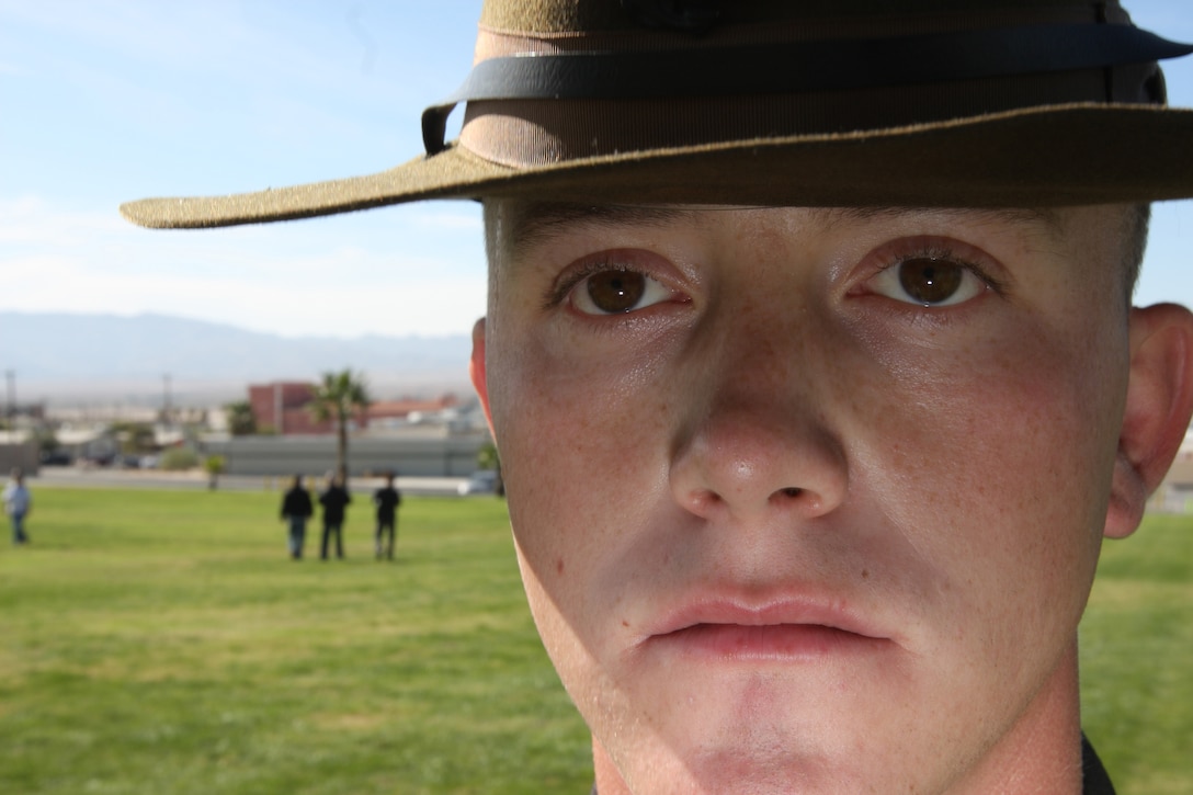 MARINE CORPS AIR GROUND COMBAT CENTER TWENTYNINE PALMS, Calif. - Cpl. Justin T. Rice, an ammunition technician with the Combat Center's Central Magazine Area dressed as an 1898 Marine who fought in Guantanamo Bay, stands stoically at parade rest after the Combat Center's 234th Marine Corps Birthday Pageant Nov. 6 at Lance Cpl. Torrey L. Grey Field. As Rice took the field, a short synopsis of the role Marines of 1898 played was read.