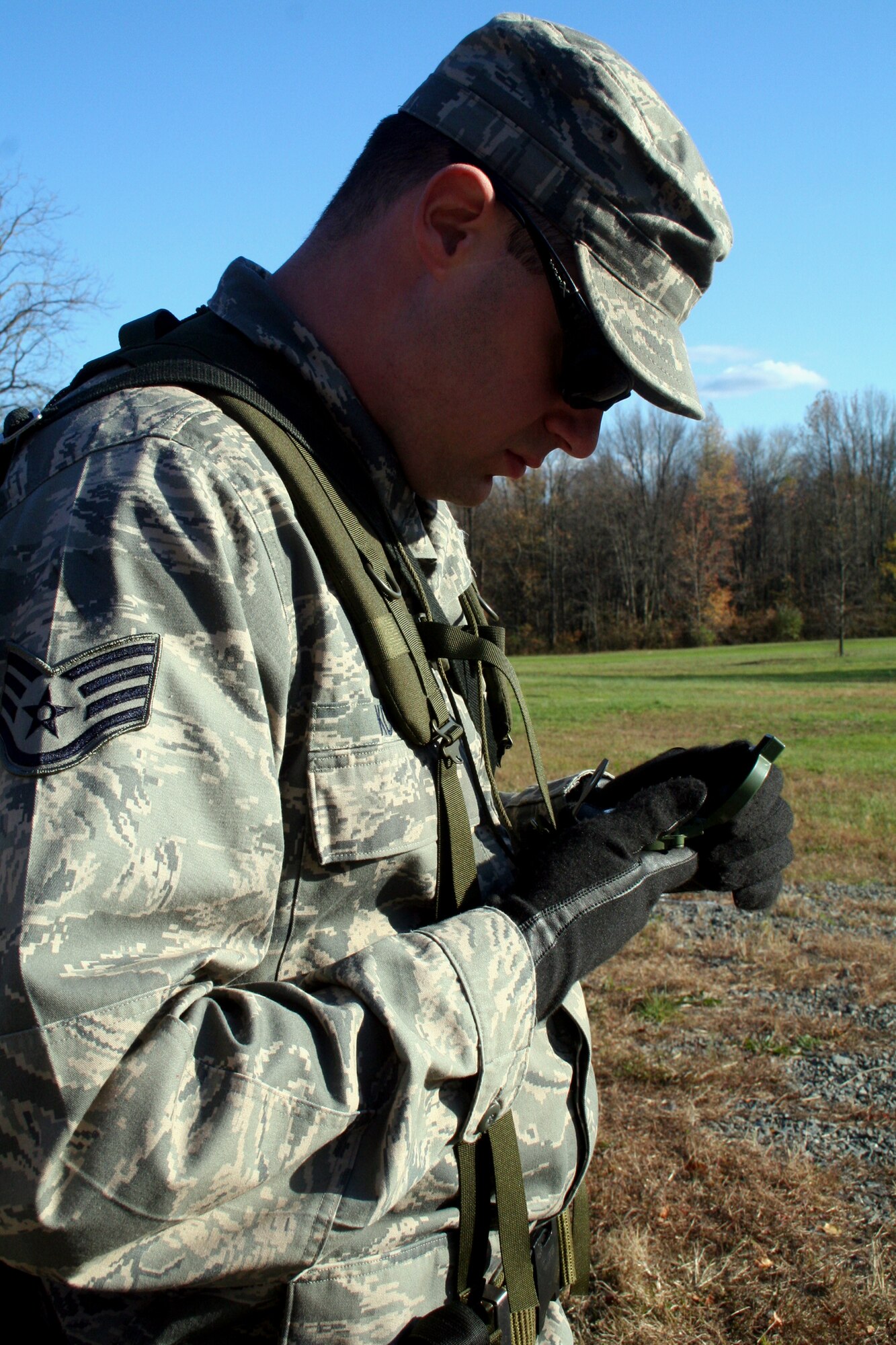 A student in the Combat Airman Skills Training Course 10-1A, taught by the U.S. Air Force Expeditionary Center's 421st Combat Training Squadron, prepares a compass for a day of land navigation training in the course on a range at Joint Base McGuire-Dix-Lakehurst, N.J., on Nov. 6, 2009.  The course prepares Airmen for upcoming deployments.  (U.S. Air Force Photo/Tech. Sgt. Scott T. Sturkol)