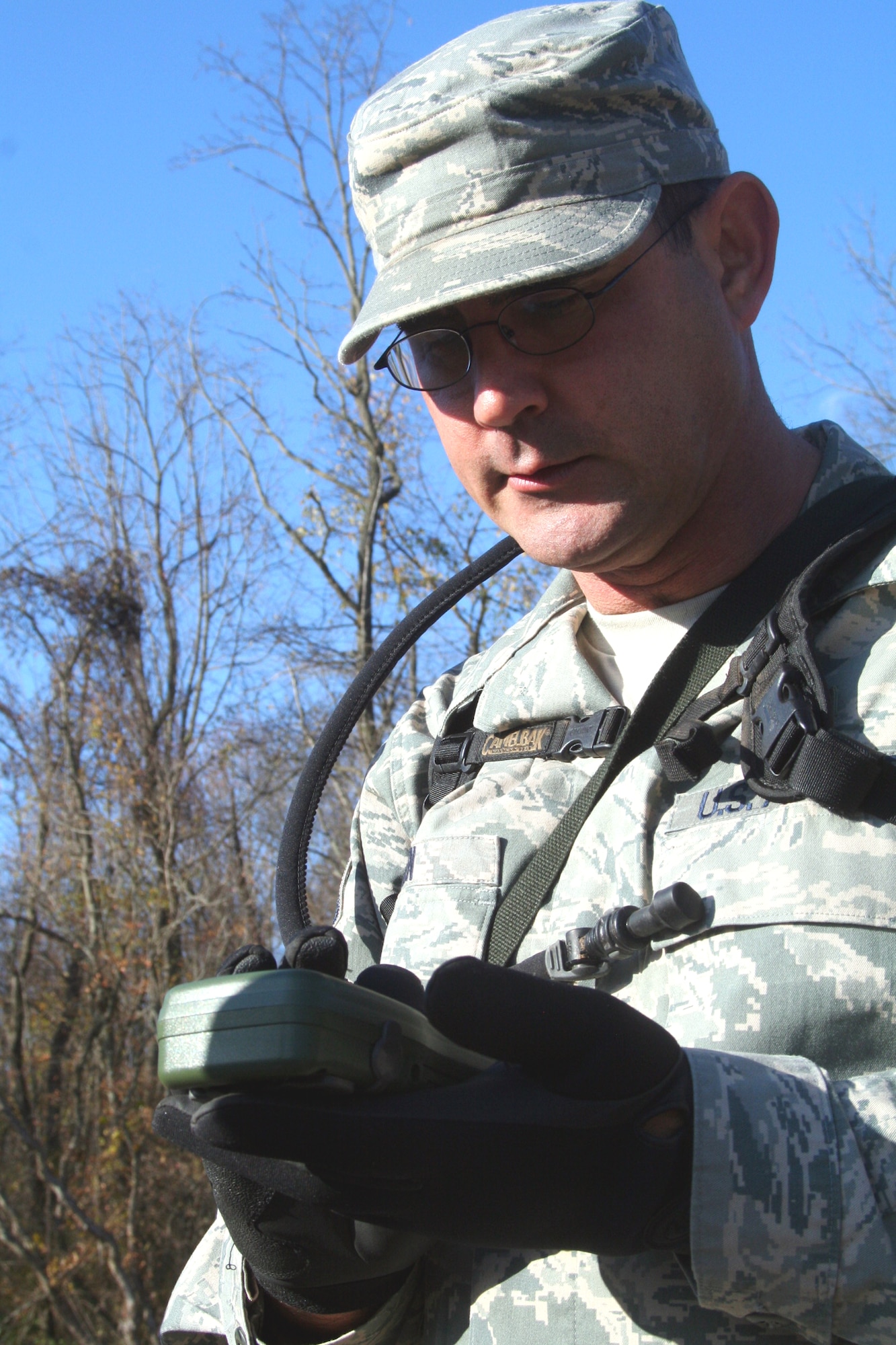 A students in the Combat Airman Skills Training Course 10-1A, taught by the U.S. Air Force Expeditionary Center's 421st Combat Training Squadron, prepares a Global Positioning System device for a day of land navigation training in the course on a range at Joint Base McGuire-Dix-Lakehurst, N.J., on Nov. 6, 2009.  The course prepares Airmen for upcoming deployments.  (U.S. Air Force Photo/Tech. Sgt. Scott T. Sturkol)