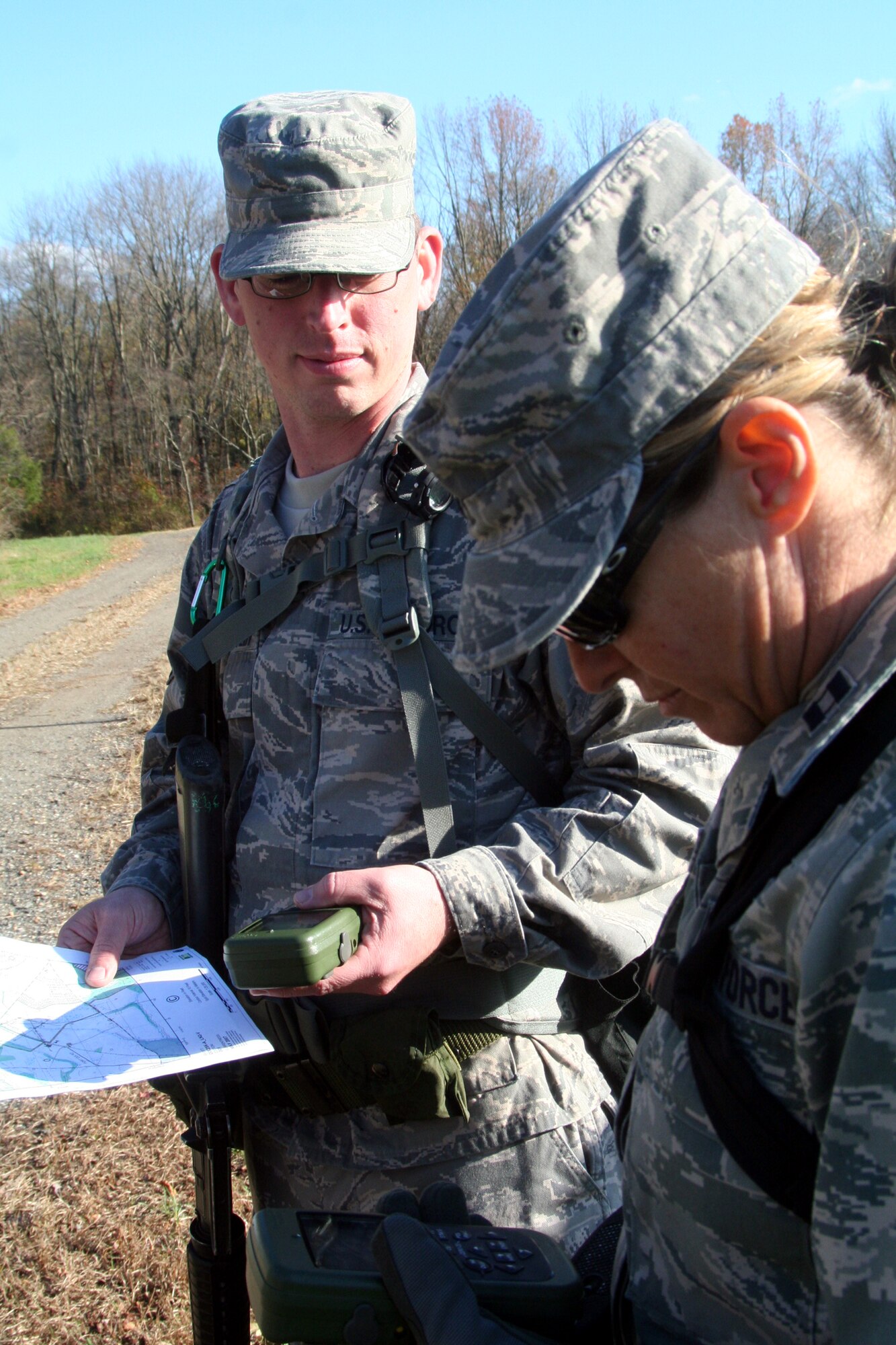 Students in the Combat Airman Skills Training Course 10-1A, taught by the U.S. Air Force Expeditionary Center's 421st Combat Training Squadron, prepare Global Positioning System devices and maps for a day of land navigation training in the course on a range at Joint Base McGuire-Dix-Lakehurst, N.J., on Nov. 6, 2009.  The course prepares Airmen for upcoming deployments.  (U.S. Air Force Photo/Tech. Sgt. Scott T. Sturkol)