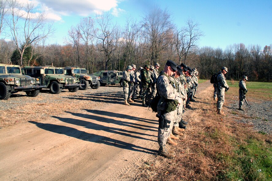 Instructors from the U.S. Air Force Expeditionary Center's 421st Combat Training Squadron and Airmen from "Echo Flight" of the Combat Airman Skills Training Course 10-1A stop for a moment of silence for the shooting victims of Fort Hood, Texas, at 2:34 p.m. on Nov. 6, 2009, on a training range at Joint Base McGuire-Dix-Lakehurst, N.J. The training instructors and students were conducting land navigation training at the range and stopped all activities for that moment to remember.  (U.S. Air Force Photo/Tech. Sgt. Scott T. Sturkol)