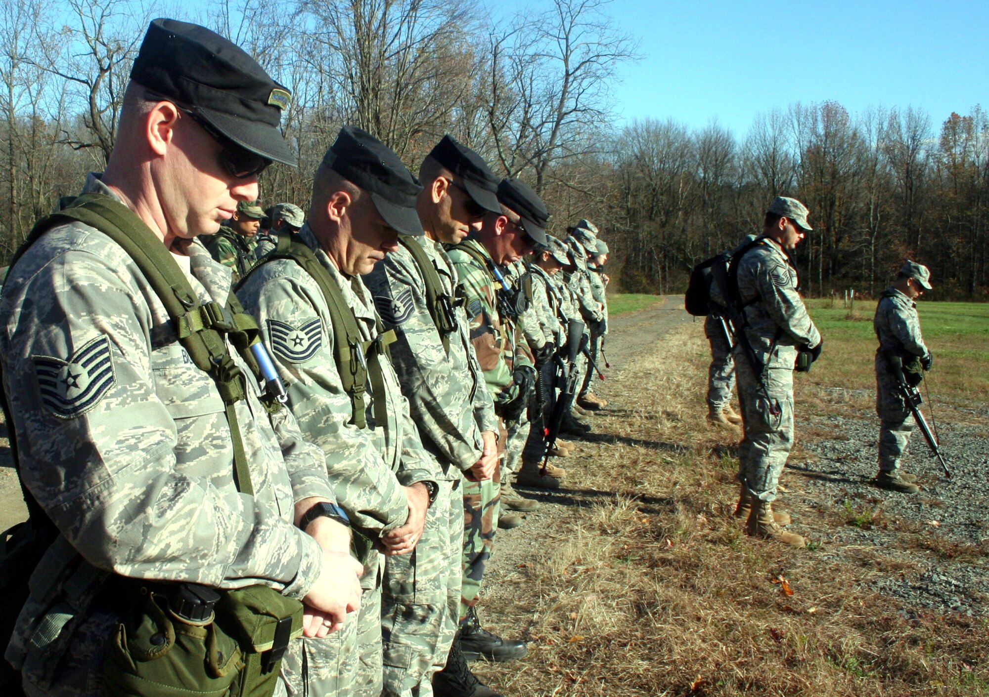 Instructors from the U.S. Air Force Expeditionary Center's 421st Combat Training Squadron and Airmen from "Echo Flight" of the Combat Airman Skills Training Course 10-1A stop for a moment of silence for the shooting victims of Fort Hood, Texas, at 2:34 p.m. on Nov. 6, 2009, on a training range at Joint Base McGuire-Dix-Lakehurst, N.J. The training instructors and students were conducting land navigation training at the range and stopped all activities for that moment to remember.  (U.S. Air Force Photo/Tech. Sgt. Scott T. Sturkol)