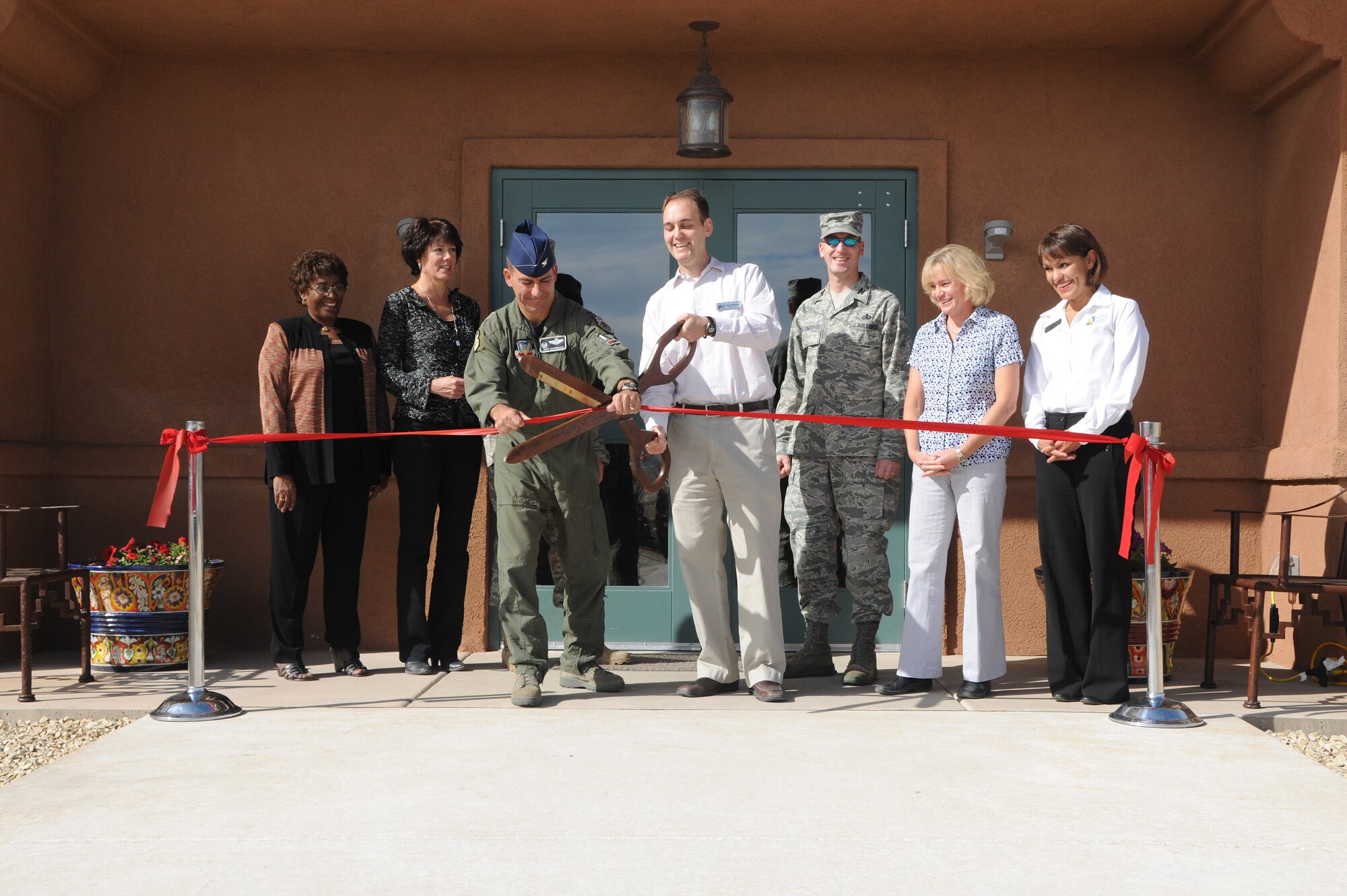 HOLLOMAN AIR FORCE BASE, N.M. -- Col. Jeff Harrigian, 49th Fighter Wing commander, and Ryan Kleinau, Soaring Heights Communities project director, cut the ceremonial ribbon signifying the grand opening of a new community center here Nov. 5. The state-of-the-art community center, located in base housing, will be open to the community Nov. 16 and features a playground, a splash park fixture, basketball court and multi-use field area for Team Holloman to enjoy.(U.S. Air Force photo by Tech. Sgt. Chris Flahive)