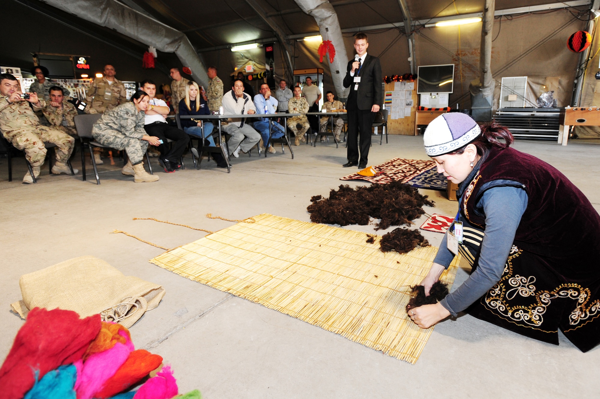Traditional Kyrgyz carpet expert Fatima Aipova prepares a carpet from wool during a demonstration as part of Kyrgyz Culture Day at the Transit Center at Manas, Kyrgyzstan, recently. (U.S. Air Force photo/Senior Airman Steele Britton)