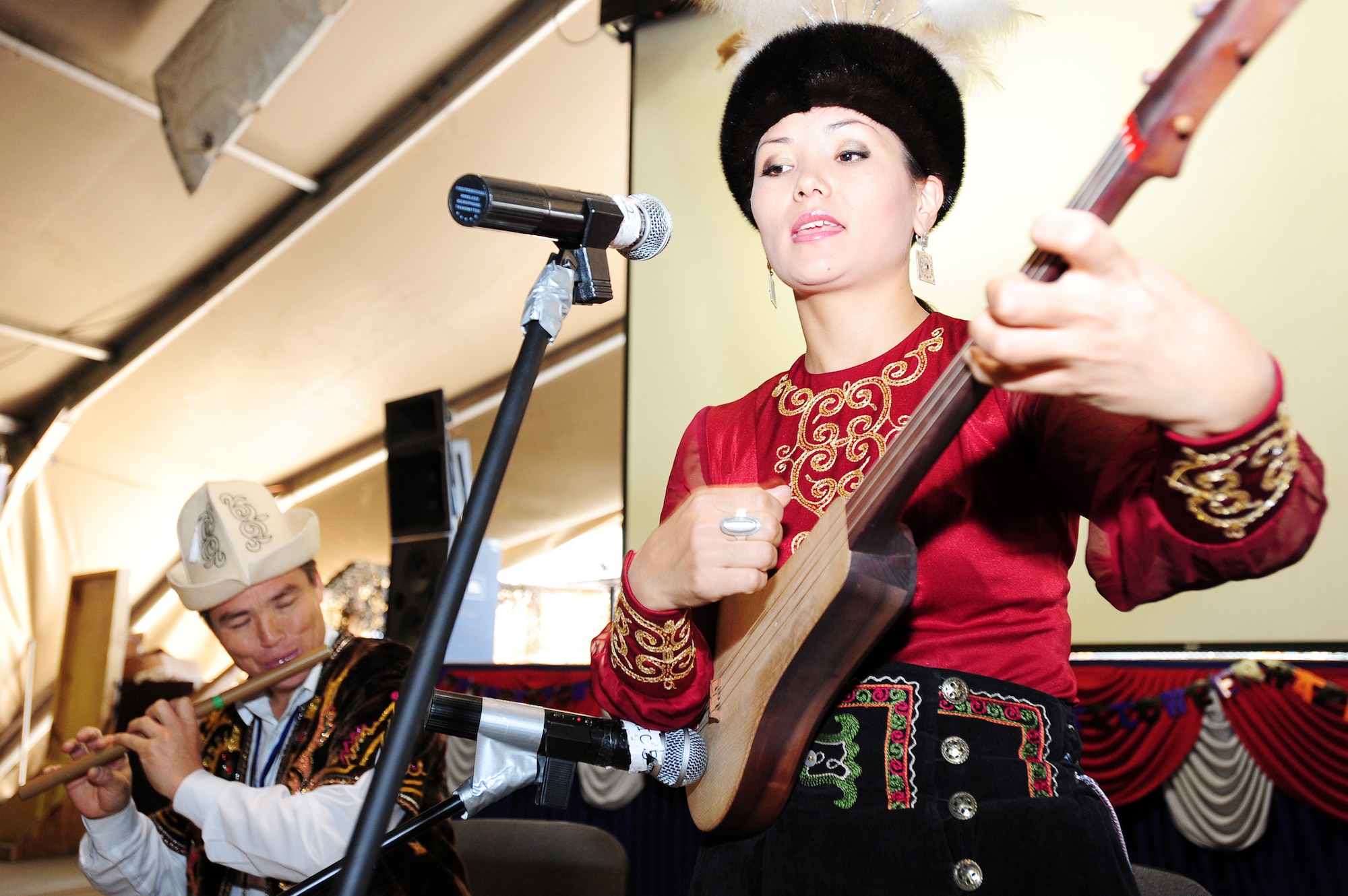 Gulinara Raimalieva plays a komuz while Sovet Adrakhaev plays a flute as part of Kyrgyz Culture Day at the Transit Center at Manas, Kyrgyzstan, Oct. 24, 2009. (U.S. Air Force photo/Senior Airman Steele Britton)