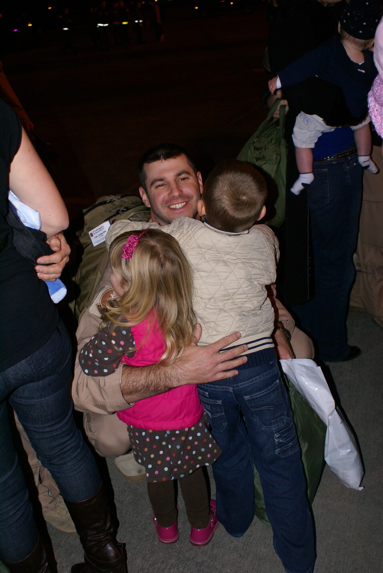 An Airman greets his children Wednesday after returning from a 120-day deployment to Southwest Asia. (U.S. Air Force photo/Tech. Sgt. Oshawn Jefferson)