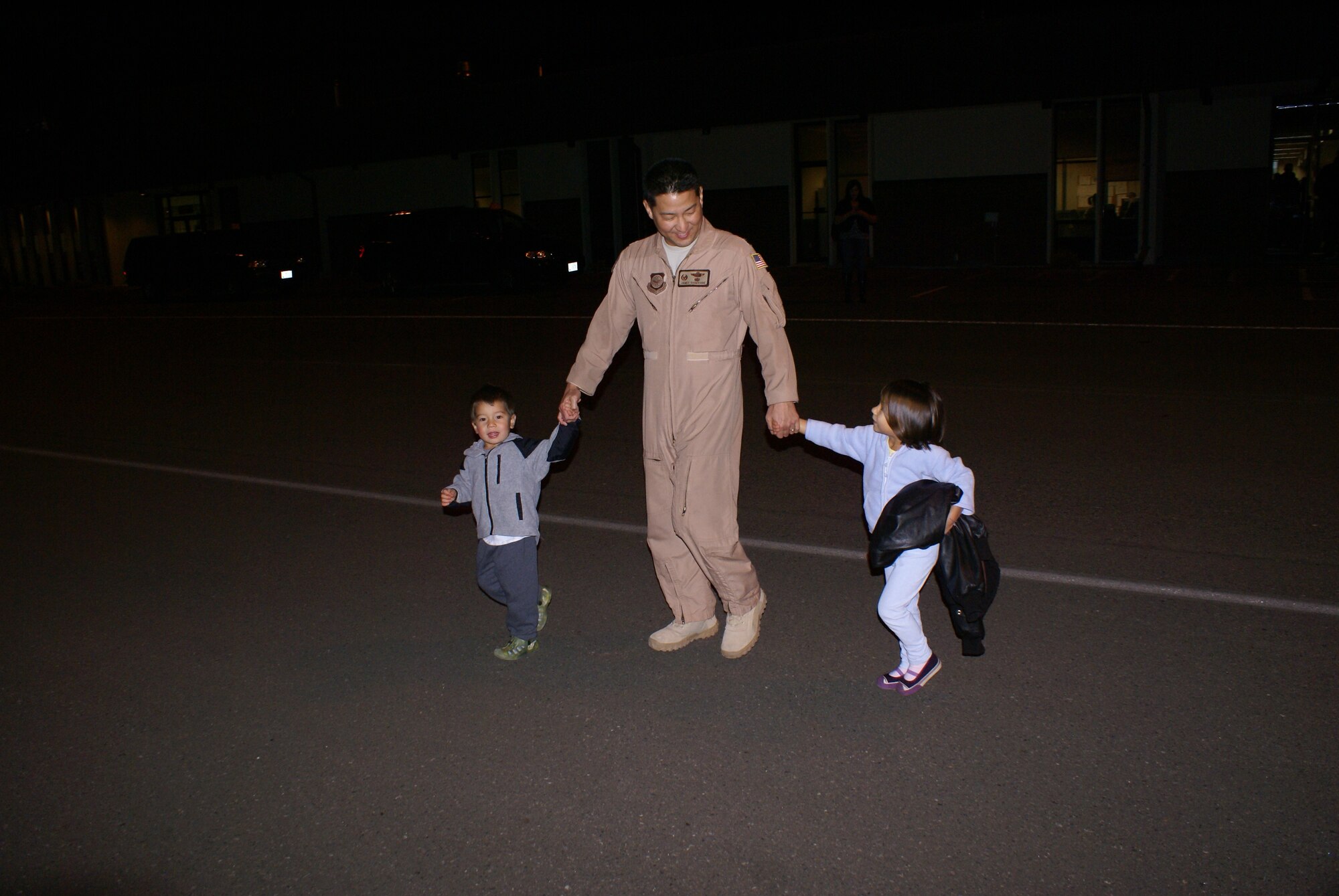 Lt. Col. James Shigekane, 10th Airlift Squadron commander, greets his children Wednesday after returning home from a 120-day deployment to Southwest Asia. (U.S. Air Force photo/Tech. Sgt. Oshawn Jefferson). 