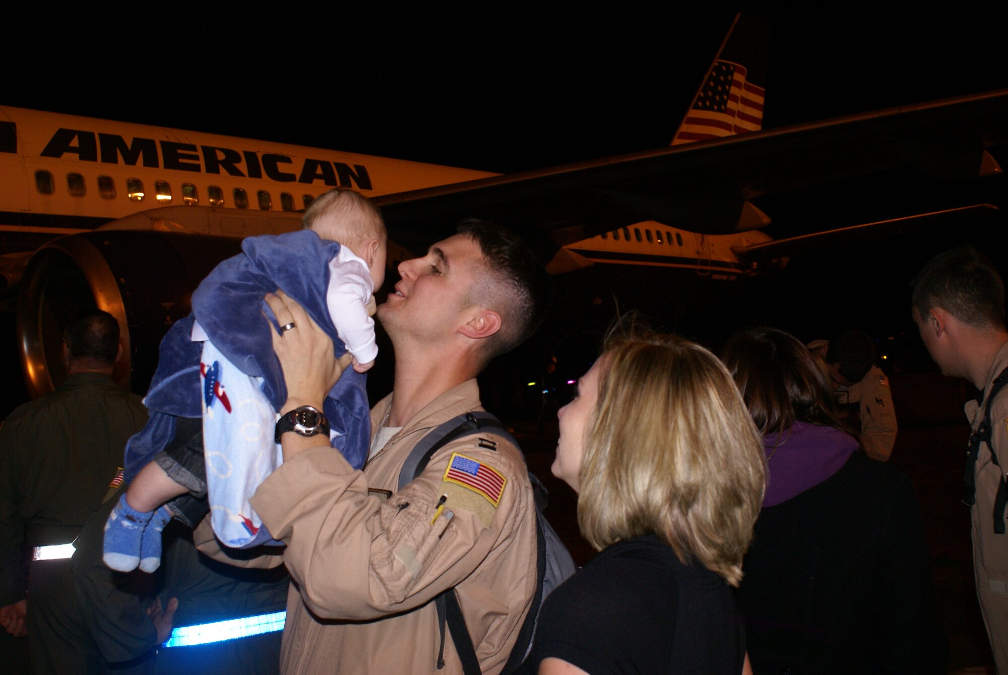 An Airman from the 10th Airlift Squadron greets his son and wife Wednesday after returning home from a 120-day deployment to Southwest Asia. (U.S. Air Force photo/Tech. Sgt. Oshawn Jefferson). 