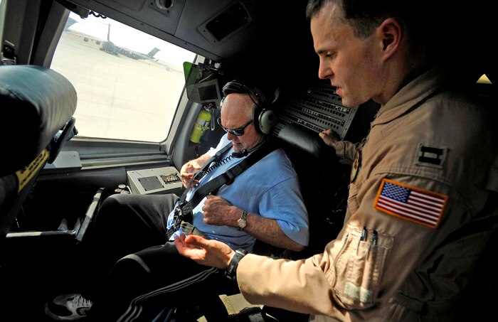 Capt. David Huffsteler (right) assists Terry Bradshaw with a co-pilot seatbelt on board a C-17 Globemaster III Nov. 5, 2009. Mr. Bradshaw, former quarterback with the Pittsburgh Steelers, was in the cockpit during takeoff of an airdrop mission. Captain Huffsteler is a C-17 Globemaster III pilot assigned to the 816th Expeditionary Airlift Squadron and deployed to Southwest Asia. (U.S. Air Force photo/Staff Sgt. Angelita Lawrence)
