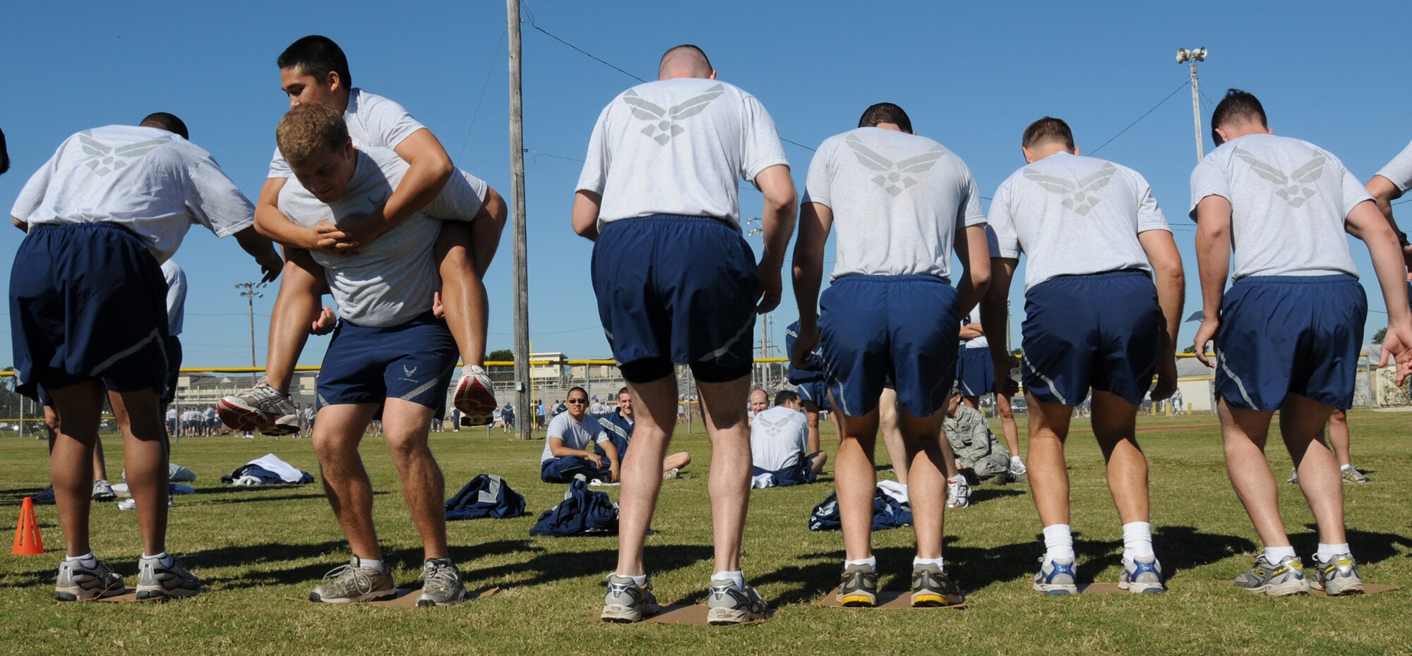 Another team of Airmen used a ‘backward’ tactic in the ‘cardboard crossing’ to achieve one of the fastest time by any team during Wingman Day at Eglin Air Force Base, Nov. 5.  Teams had to move from one side of the field to the other by walking on cardboard squares.  Teams came up with varying game plans to get their members to the other side without taking their feet off the cardboard.  (Air Force photo/Samuel King Jr.)