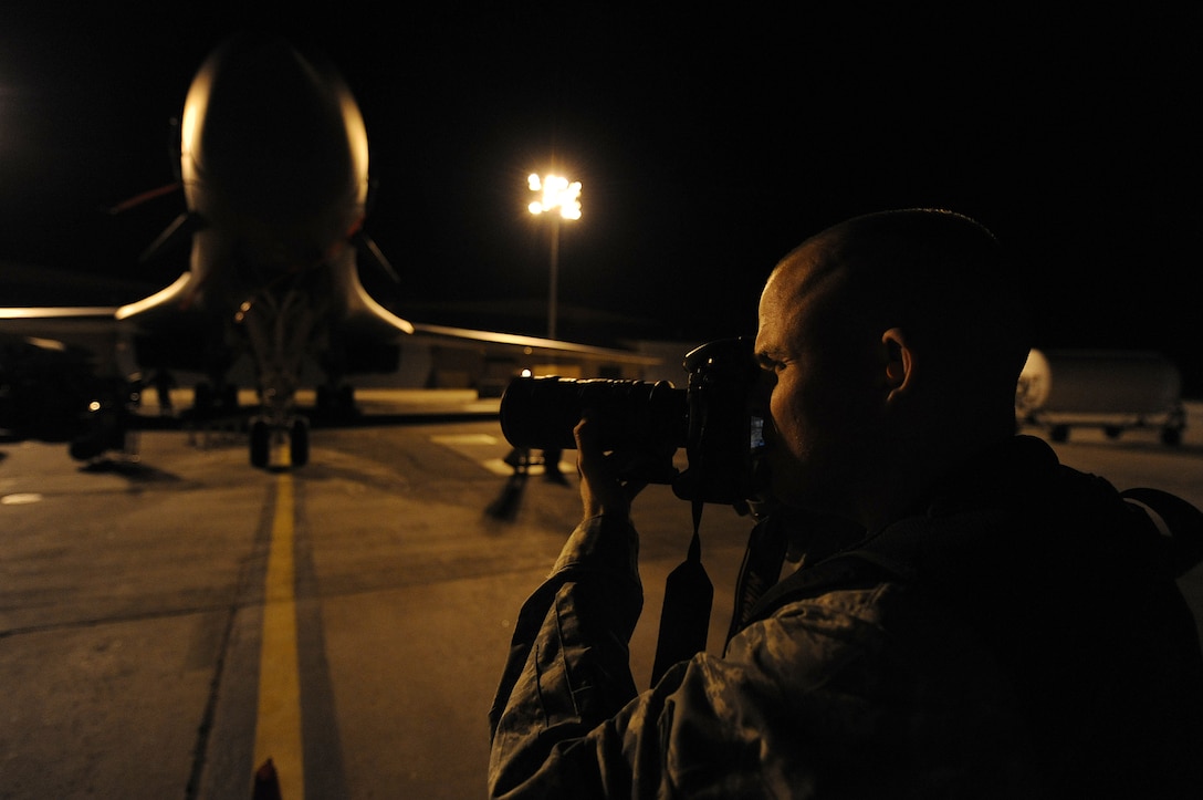 ELLSWORTH AIR FORCE BASE, S.D. -- Airman 1st Class Corey Hook, 28th Bomb Wing still photographic journeyman, takes photos of Airmen performing maintenance on B-1B Lancers, Nov. 4. Air Force photographers document the work of Airmen daily, in order to tell the Air Force story. (U.S. Air Force photo/Airman 1st Class Joshua J. Seybert)