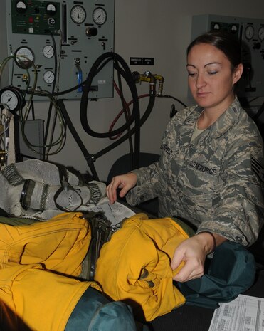 Staff Sgt. Natasha Wakefield, Air Space Physiologist with the 9th Physiological Support Squadron, depressurizes a U-2 flight suit during a routine maintenance check. Sergeant Wakefield inspects more than 30 line items, ensuring the suit is ready for flight. (U.S Air Force photo by Senior Airman Kevin Iinuma) 