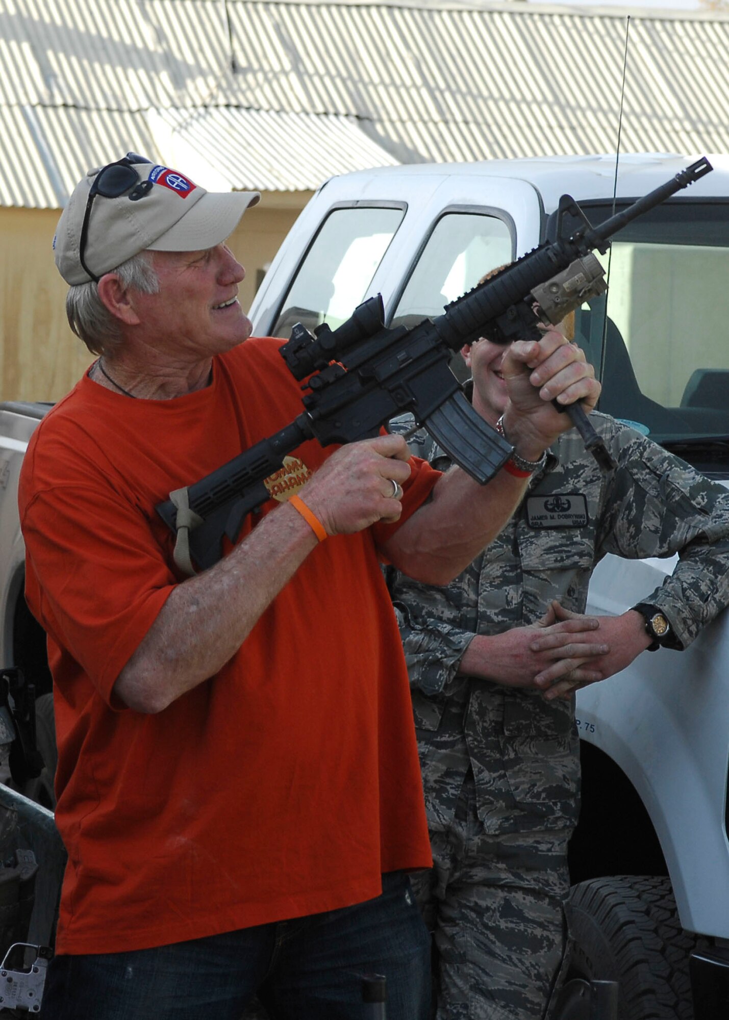 Terry Bradshaw, a member of the "Fox NFL Sunday" team, handles a M4 carbine while visiting the 755th Air Expeditionary Group's Explosive Ordnance Disposal flight Nov. 6, 2009, at Bagram Airfield, Afghanistan. The team of Curt Menefee, Terry Bradshaw, Howie Long, Michael Strahan, Jimmy Johnson and Jay Glazer is scheduled to broadcast live Nov. 8, 2009 from here. (U.S. Air Force photo/Senior Airman Felicia Juenke)