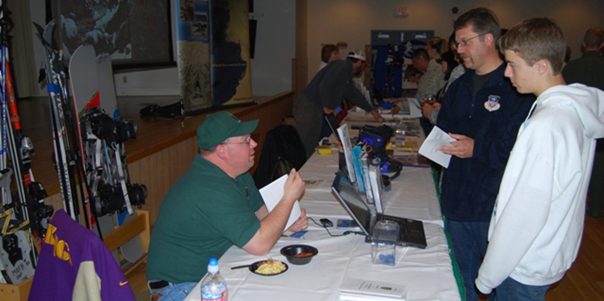 Tom Kiernan, an employee at Outdoor Recreation, explains how the season rentals work with two prospective new skiers, during the Ski Expo and Dessert and Wine Fair Oct. 29, 2009. (U.S. Air Force photo/Airman 1st Class Kristina Overton)