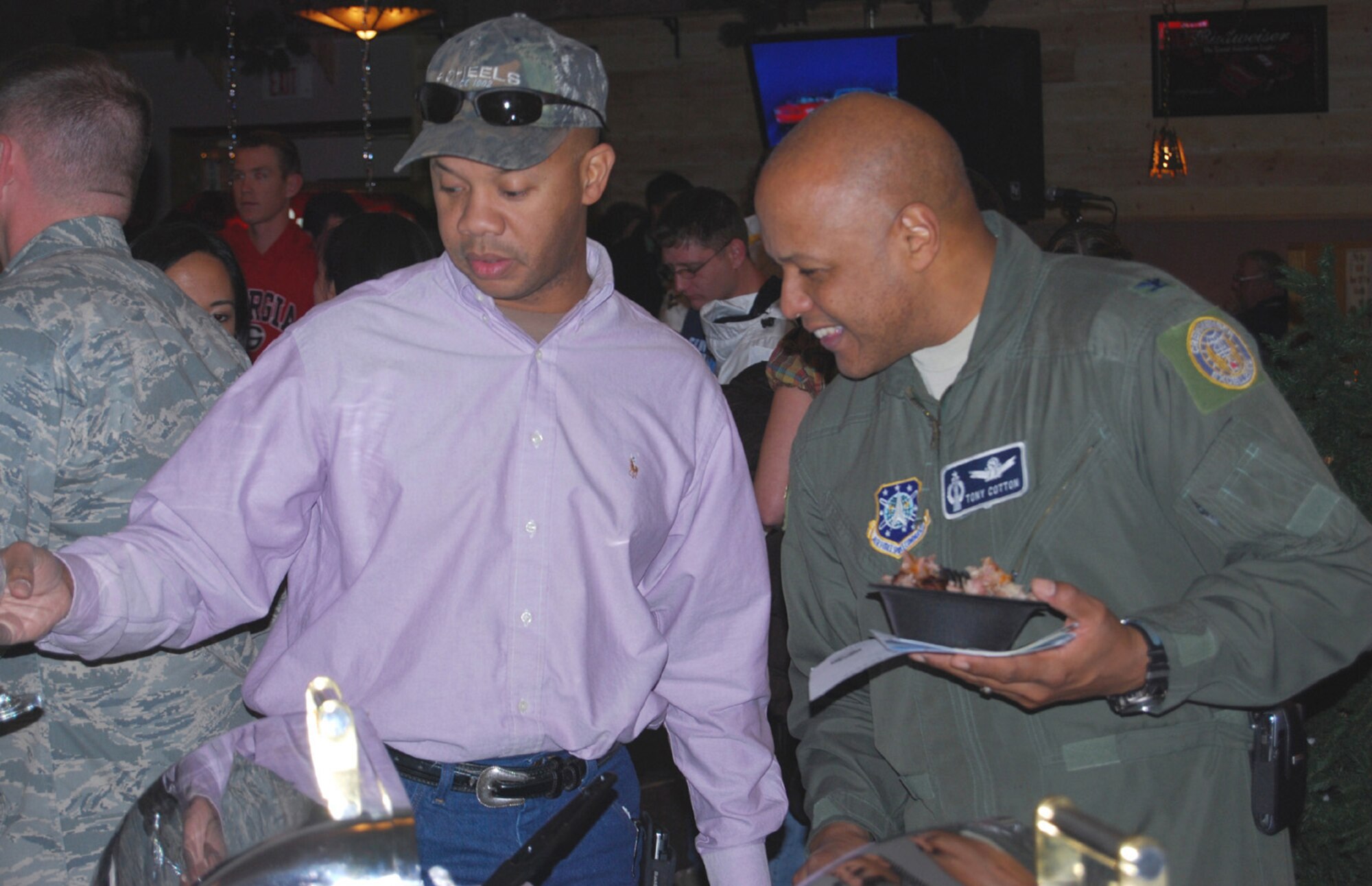 Col. Anthony Cotton, 341st Missile Wing vice commander, and Army 1st Lt. Reg Taylor scan through the hot buffet items at the Ski Expo and Dessert and Wine Fair Oct. 29, 2009. (U.S. Air Force photo/ Airman 1st Class Kristina Overton.)