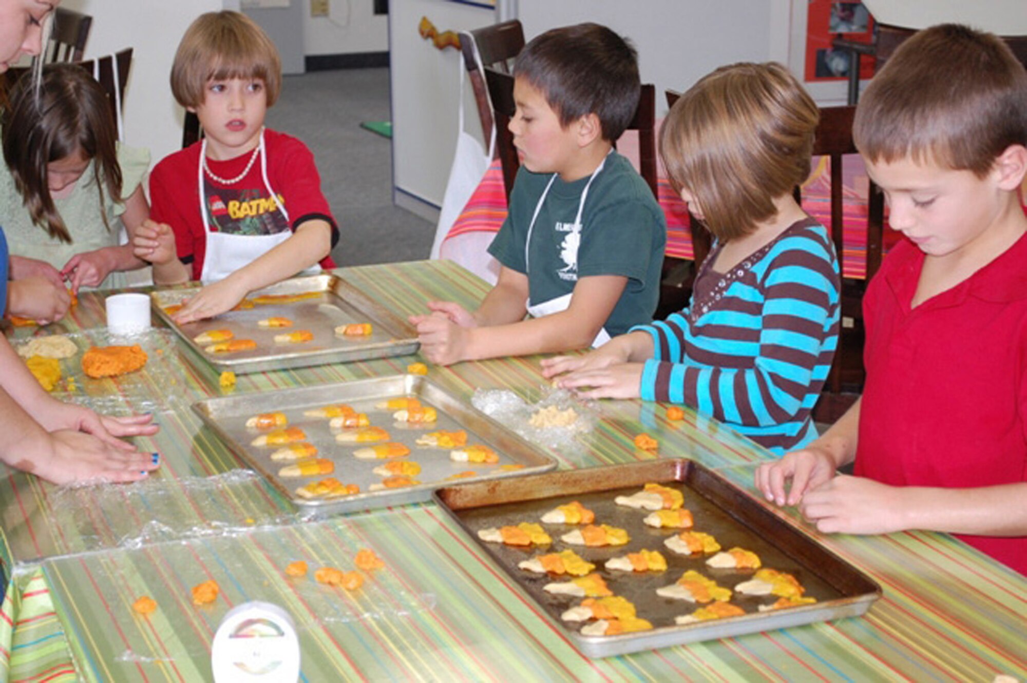 Members of Malmstrom's Youth Center 4-H Club shape candy corn cookies for the program's cooking class on Friday, Oct.16, 2009. (U.S. Air Force photo/Airman 1st Class Kristina Overton)