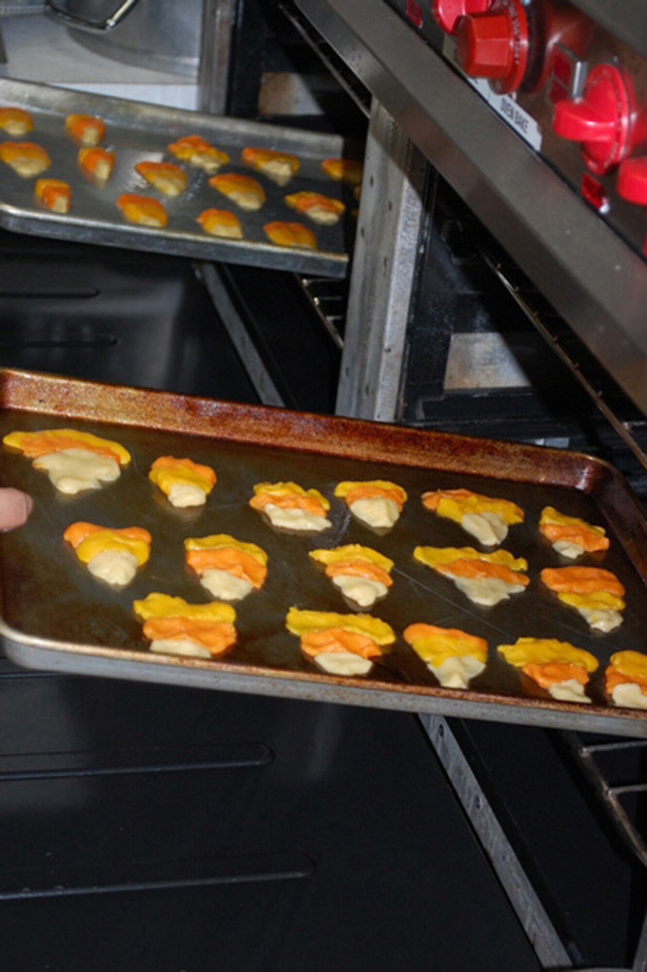 Members of Malmstrom's Youth Center 4-H Club shape candy corn cookies for the program's cooking class on Friday, Oct.16, 2009. (U.S. Air Force photo/Airman 1st Class Kristina Overton)