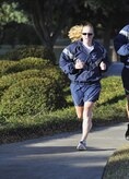 Capt. Kay Hasson finishes first for the women during the Commander's 5K Run/Walk Challenge held here Nov. 6 with a time of 22:11. The fastest male and female runners were recognized by 437th Airlift Wing Commander Col. John Wood. Captain Hasson is a pilot with the 14th Airlift Squadron and a 437 AW executive officer. (U.S. Air Force photo/James Bowman)