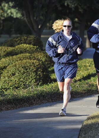 Capt. Kay Hasson finishes first for the women during the Commander's 5K Run/Walk Challenge held here Nov. 6 with a time of 22:11. The fastest male and female runners were recognized by 437th Airlift Wing Commander Col. John Wood. Captain Hasson is a pilot with the 14th Airlift Squadron and a 437 AW executive officer. (U.S. Air Force photo/James Bowman)