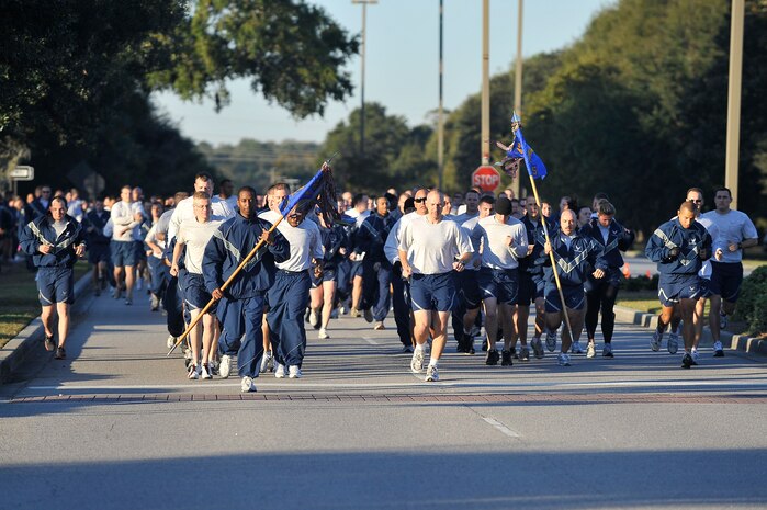 Team Charleston members run down Hill Boulevard during the Commander's 5K Run/Walk Challenge held here Nov. 6. During the fitness challenge, road guards guide traffic away from runners as they make their way from the Fitness and Sports Center. More than 530 Airmen from various base squadrons came out to participate in the challenge. (U.S. Air Force photo/James Bowman)