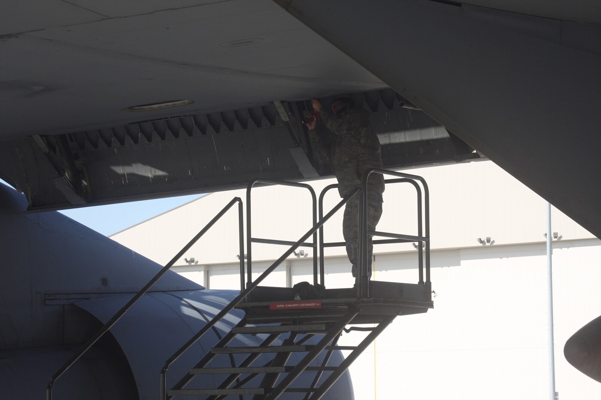 WRIGHT-PATTERSON AIR FORCE BASE, Ohio – Airman First Class Mike Bernat, 445th Aircraft Maintenance Squadron, does some spot work underneath the wing of a C-5 Galaxy.  The 445th Airlift Wing has 10 C-5s, which are the largest aircraft in the Air Force inventory. (U. S. Air Force photo/Stacy Vaughn)