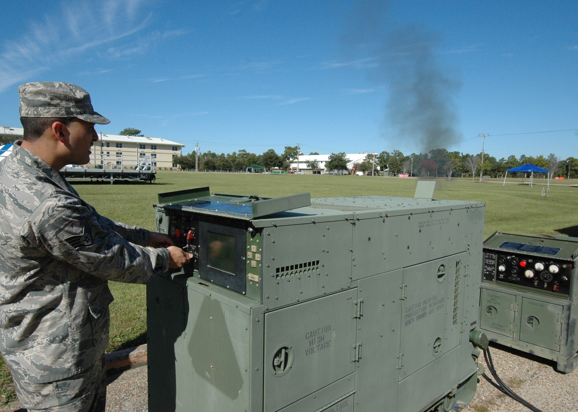 A puff of smoke rises when Staff Sgt. William Bonner, 919th Communications Squadron, flips the switch to start the computer-run generator to be used for the UTA weekend's "Family Day" at Duke Field.  It was just one of three generators the squadron would hook up Nov. 6.  (Air Force photo/Staff Sgt. Samuel King Jr.)