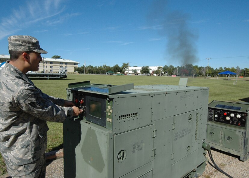 A puff of smoke rises when Staff Sgt. William Bonner, 919th Communications Squadron, flips the switch to start the computer-run generator to be used for the UTA weekend's "Family Day" at Duke Field.  It was just one of three generators the squadron would hook up Nov. 6.  (Air Force photo/Staff Sgt. Samuel King Jr.)