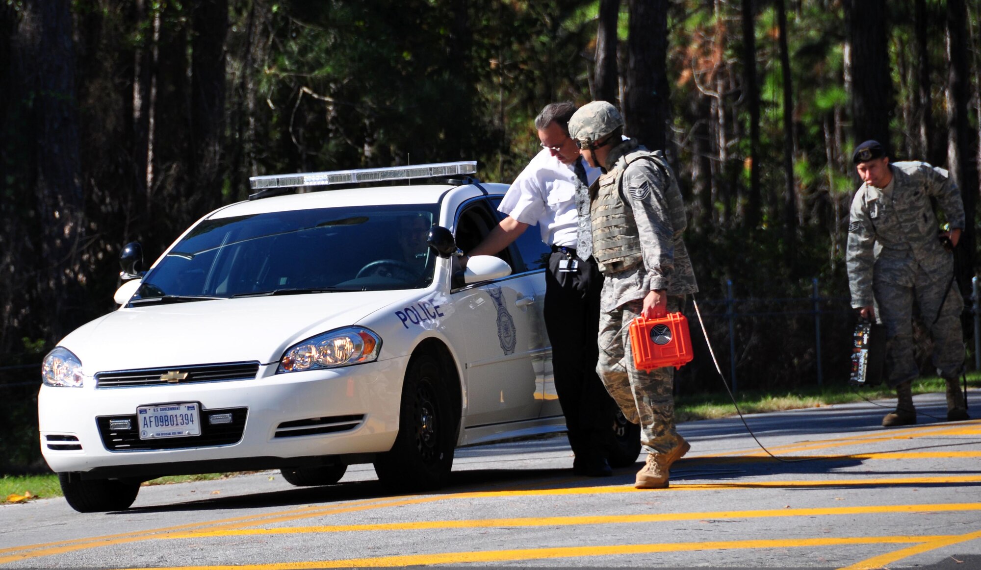 Mr. Mark Smith, Panama City Police Department, Tech. Sgt Rene Contreras, 325th Security Forces Squadron, and Staff Sgt. Luis Ramos, 325th Security Forces Squadron, take part in a base exercise Nov. 5 at the Sabre Gate. (U.S. Air Force photo by Airman 1st Class Rachelle Elsea)