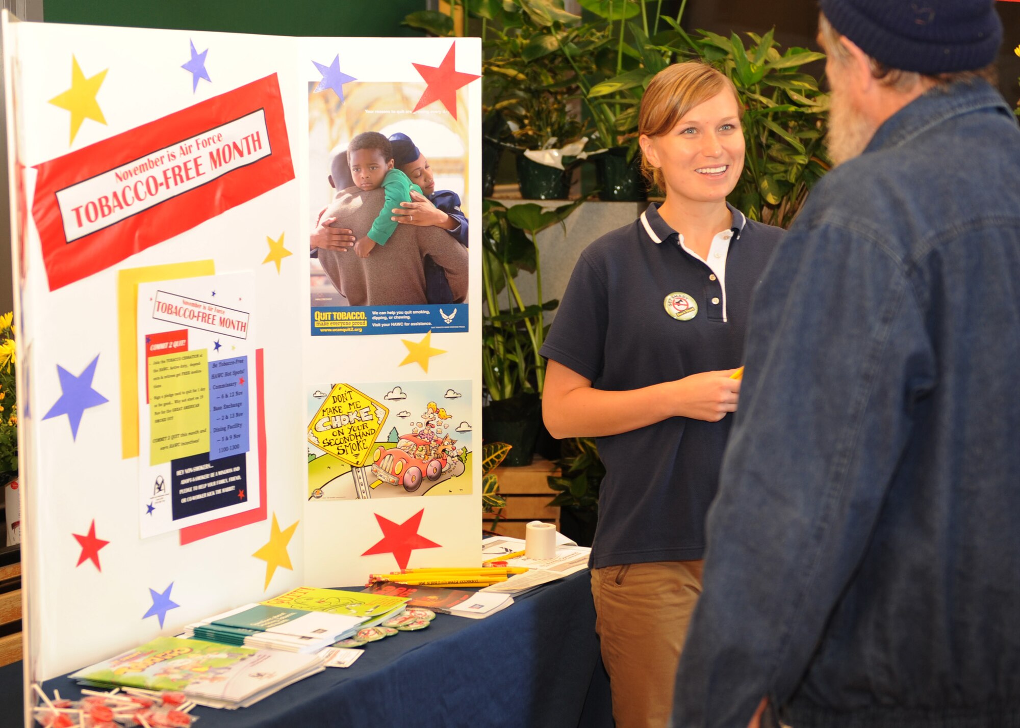 SCOTT AIR FORCE BASE, Ill -- Laura Weiglein, Health and Wellness Center health technician, talks with Charles Mercurio III, at the HAWC information table setup inside the Scott Commissary on Friday. The table will be located inside many base facilities in the next week as part of the U.S. Air Force “Year of the Military Family” program. (U.S. Air Force photo/Airman 1st Class Wesley Farnsworth)