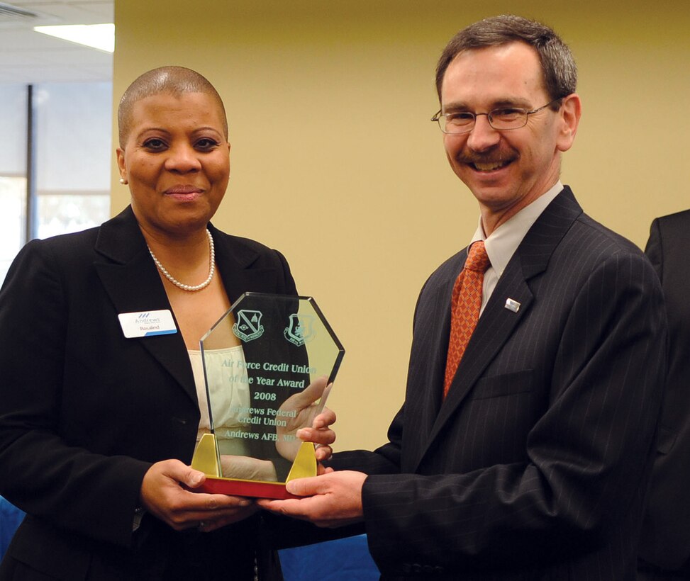 Robert Flanyak, Andrews Federal member services vice president, presents the 2008 Air Force Credit Union of the Year award to Rosalind Bishop, branch manager, at the Andrews Federal Credit Union, located on Joint Base Andrews, Monday. The award was given by the Department of the Air Force in recognition for commitment to financial literacy, tailored products and service offerings, military community support, and their relationship with Andrews personnel. (U.S. Air Force photo/ Airman 1st Class Melissa Rodrigues)
